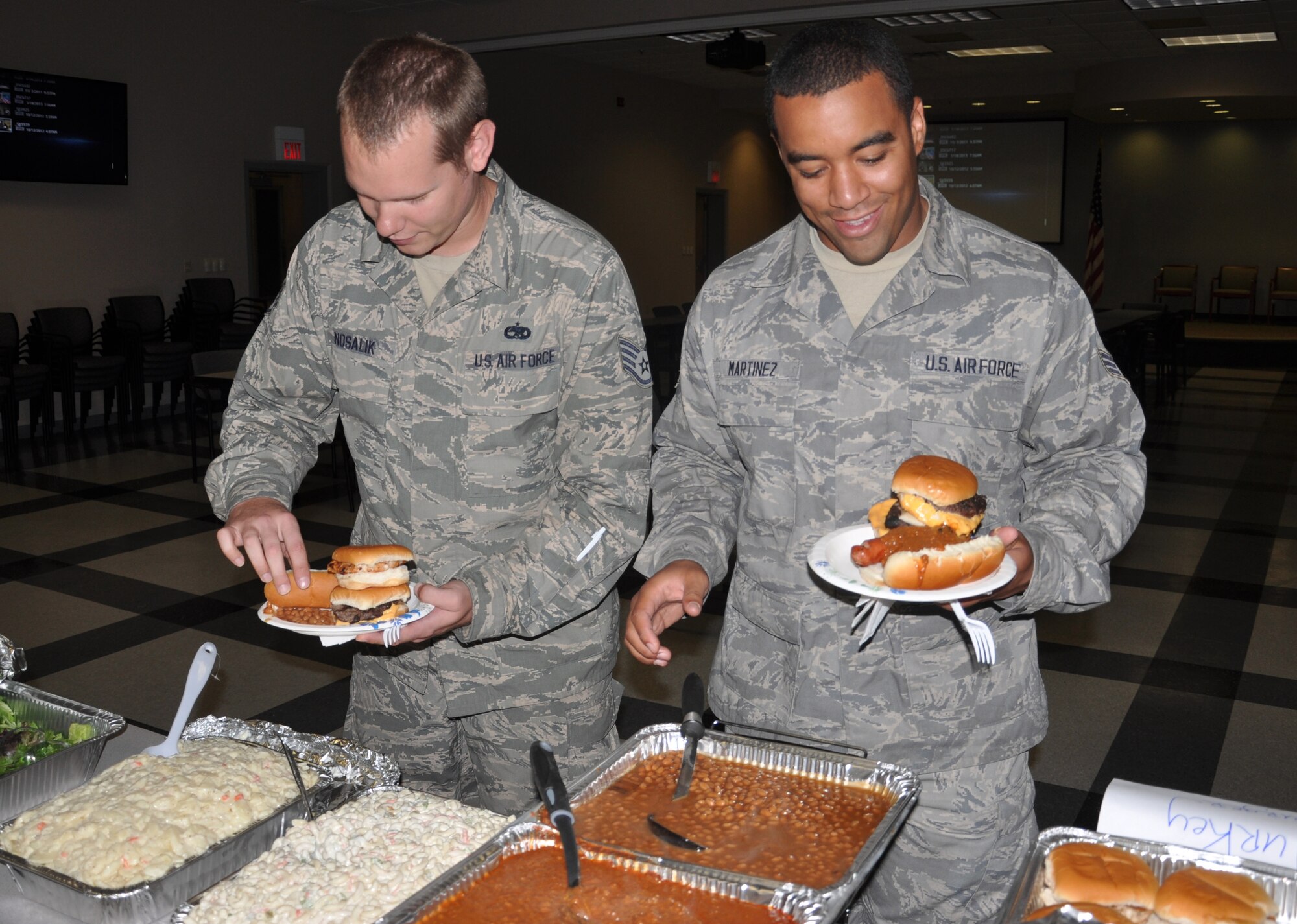 Two members of the 514th Maintenance Squadron load their plates with freshly grilled hamburgers and hot dogs at the Hot Diggity Dog Day held here Sept. 26. Civilian personnel, Air Reserve Technicians and reservists were treated to a complimentary lunch hosted by 514th Air Mobility Wing staff to celebrate the closing year’s accomplishments and withstanding tough financial and personal challenges throughout fiscal year 2013 (U.S. Air Force photo/Senior Airman Chelsea Smith).