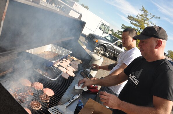 Staff Sgt. Aristide Colonna and Senior Airman Donald Ramos, 514th Air Mobility Wing chaplain assistants, oversee the grill at the Hot Diggity Dog Day held here Sept. 26. Freedom wing members closed out the year at a barbeque lunch celebrating their resiliency and triumph over external challenges including the devastating effects of Hurricane Sandy and financial setbacks of the recent government furlough (U.S. Air Force photo/Senior Airman Chelsea Smith). 