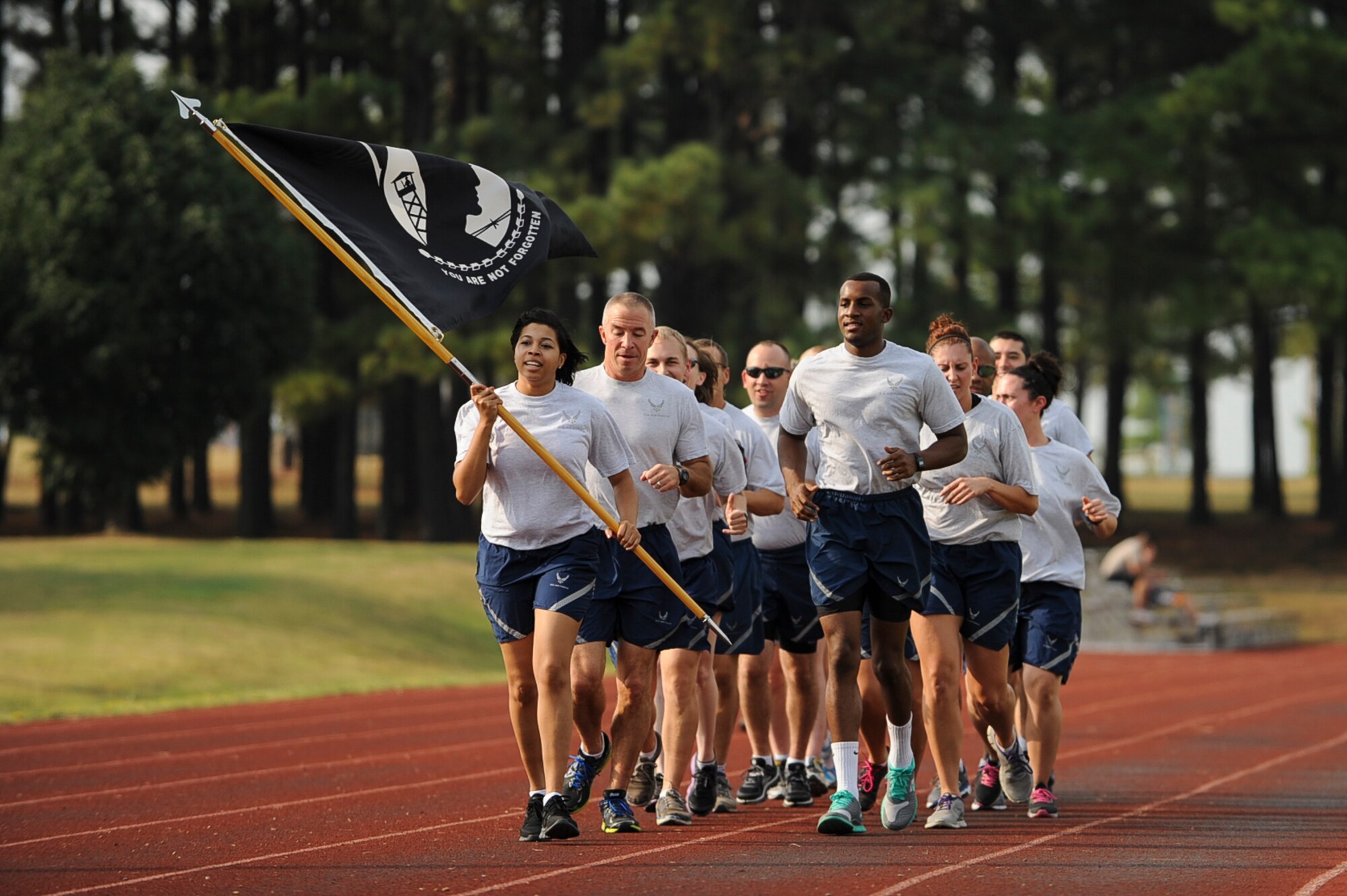 Members of the 19th Medical Group begin the Prisoner of War/Missing in Action Recognition Day run Sept. 19, 2013, at Little Rock Air Force Base, Ark. Team Little Rock Airmen carried the POW/MIA flag during a 24-hour run. (U.S. Air Force photo by Airman 1st Class Cliffton Dolezal)