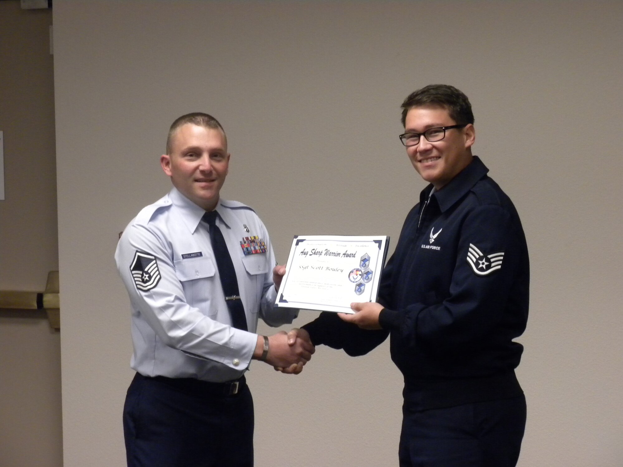 PETERSON AIR FORCE BASE, Colo. – Master Sgt. Dan Stellabotte, on behalf of the Pikes Peak Top 3, presents the August Sharp Warrior Award to Staff Sgt. Scott Bouley, 544th Intelligence, Surveillance and Reconnaissance Group. Bouley took charge of a finance program that had been without consistent FM presence for more than a year and restored the program and positively affected seven worldwide units. Bouley was also recognized by the 70th ISR Wing commander for outstanding performance. His demonstrated dedication and professionalism on and off duty led to his selection as the Sharp Warrior. (U.S. Air Force photo)