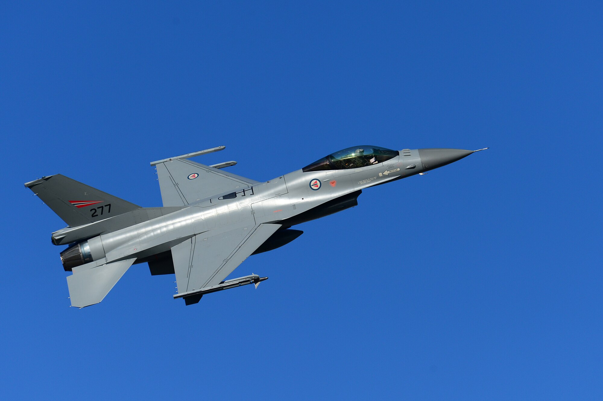 A Royal Norwegian Air Force F-16 Falcon flies above Bodø Main Air Station, Norway, Sept. 24, 2013. Norway was the host nation for the Arctic Challenge Exercise 2013. ACE-13 was a combined exercise with NATO allies and regional partners designed to build upon international relationships. (U.S. Air Force photo by Master Sgt. Lee Osberry/Released)