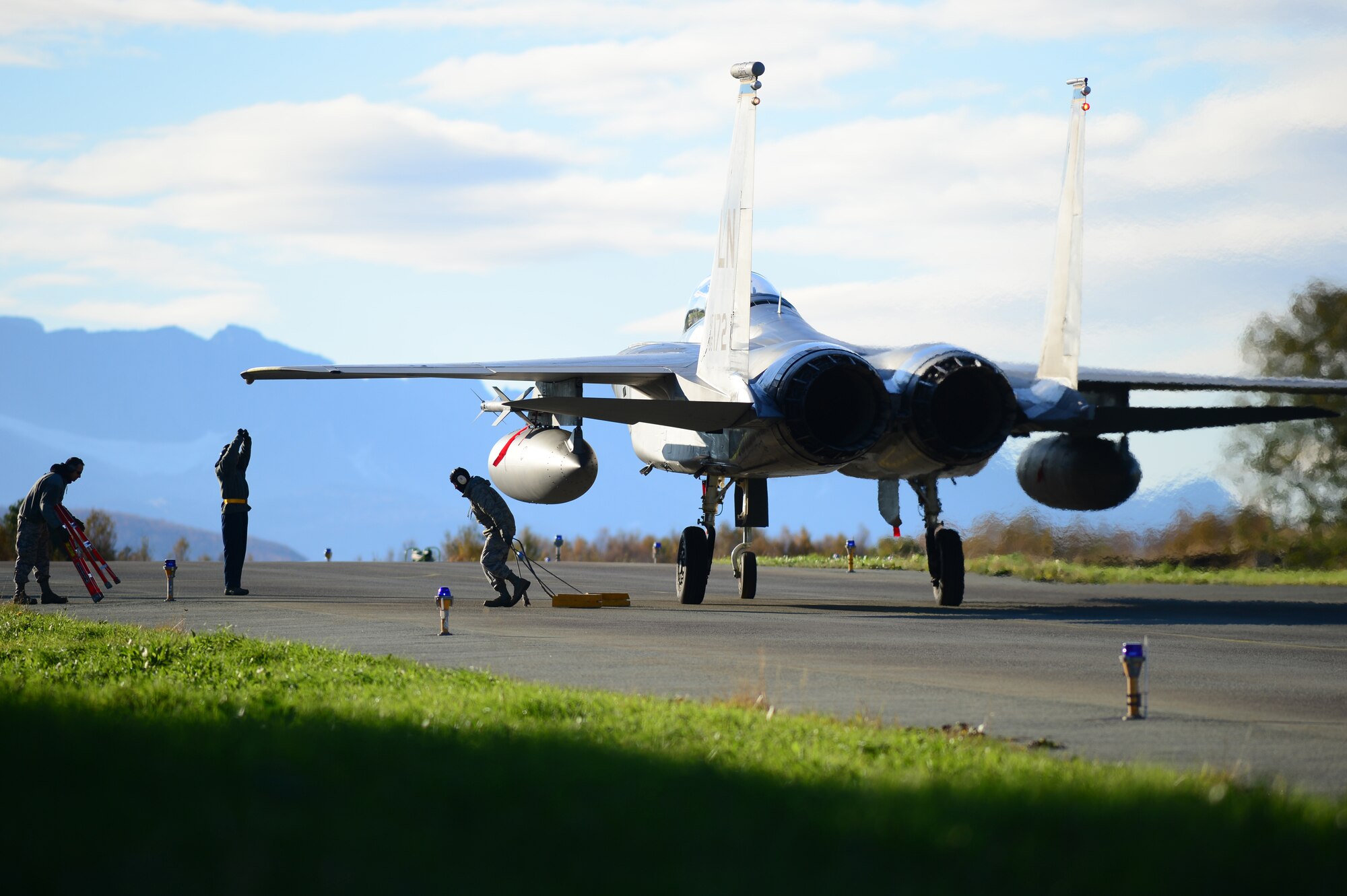 Maintenance Airmen from the 748th Aircraft Maintenance Squadron prepare to release an F-15C Eagle for taxi at Bodø Main Air Station, Norway, Sept. 24, 2013. The Airmen were amongst approximately 600 personnel deployed from multiple bases within U.S. Air Forces in Europe-Air Forces Africa, supporting the Arctic Challenge Exercise 2013. ACE-13 was a combined exercise with NATO and regional allies, which promoted continued interoperability between the United States, Norway, Sweden, Finland, United Kingdom and NATO. (U.S. Air Force photo by Master Sgt. Lee Osberry/Released)