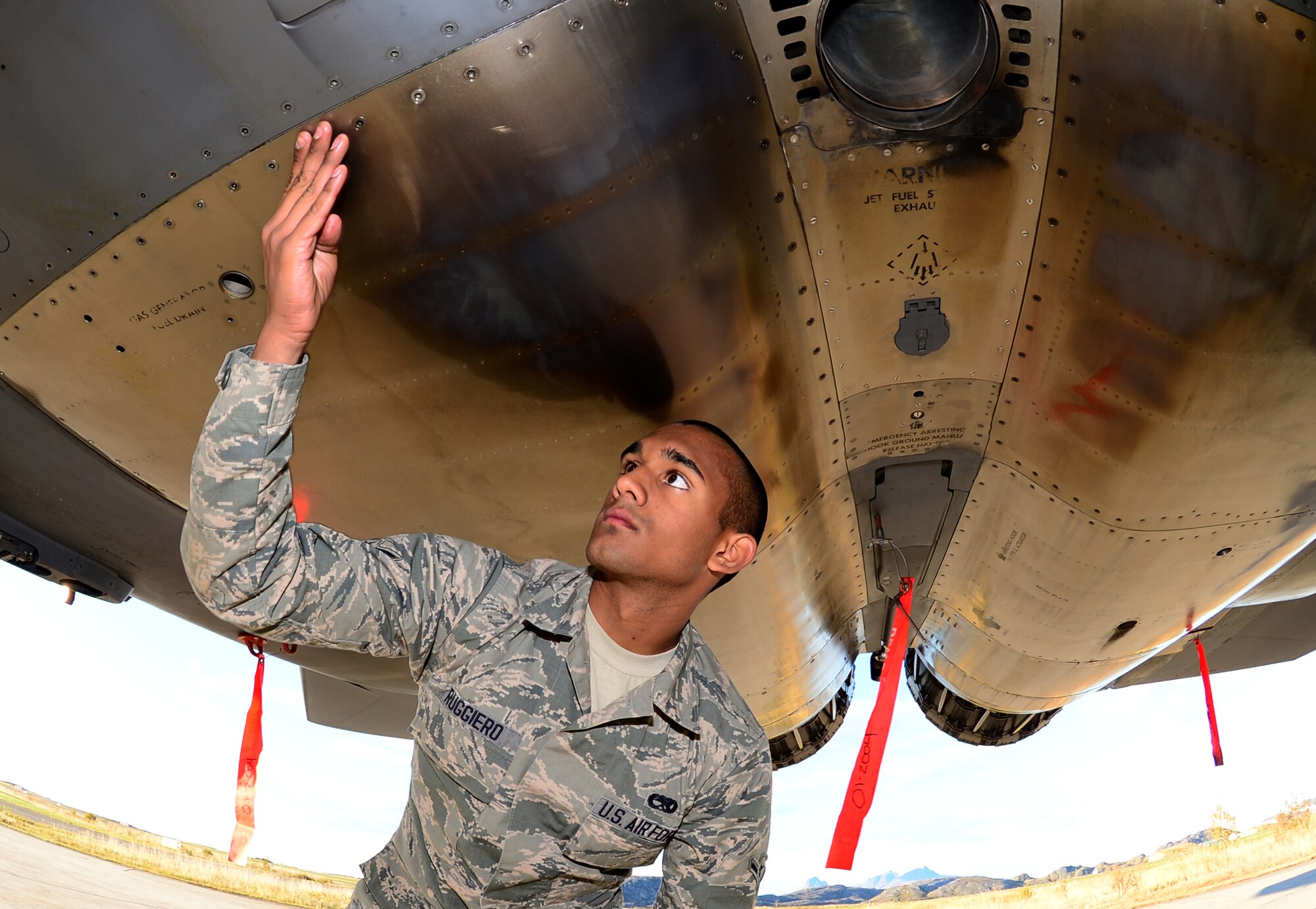 Airman Joseph Ruggiero, 494th Aircraft Maintenance Unit crew chief, checks the rivets underneath an F-15E Strike Eagle at Bodø Main Air Station, Norway, Sept. 24, 2013. Ruggiero was amongst approximately 600 personnel deployed from multiple bases within U.S. Air Forces in Europe-Air Forces Africa, supporting the Arctic Challenge Exercise 2013. ACE-13 was a combined exercise with NATO and regional allies, which promoted continued interoperability between the United States, Norway, Sweden, Finland, United Kingdom and NATO. (U.S. Air Force photo by Master Sgt. Lee Osberry/Released)