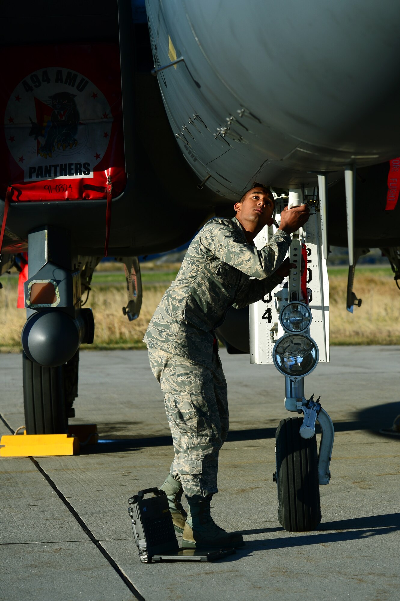 Airman Joseph Ruggiero, 494th Aircraft Maintenance Unit crew chief, inspects the landing gear of an F-15E Strike Eagle as part of post flight checks at Bodø Main Air Station, Norway, Sept. 24, 2013. Ruggiero was amongst approximately 600 personnel deployed from multiple bases within U.S. Air Forces in Europe-Air Forces Africa, supporting the Arctic Challenge Exercise 2013. ACE-13 was a combined exercise with NATO and regional allies, which promoted continued interoperability between the United States, Norway, Sweden, Finland, United Kingdom and NATO. (U.S. Air Force photo by Master Sgt. Lee Osberry/Released)