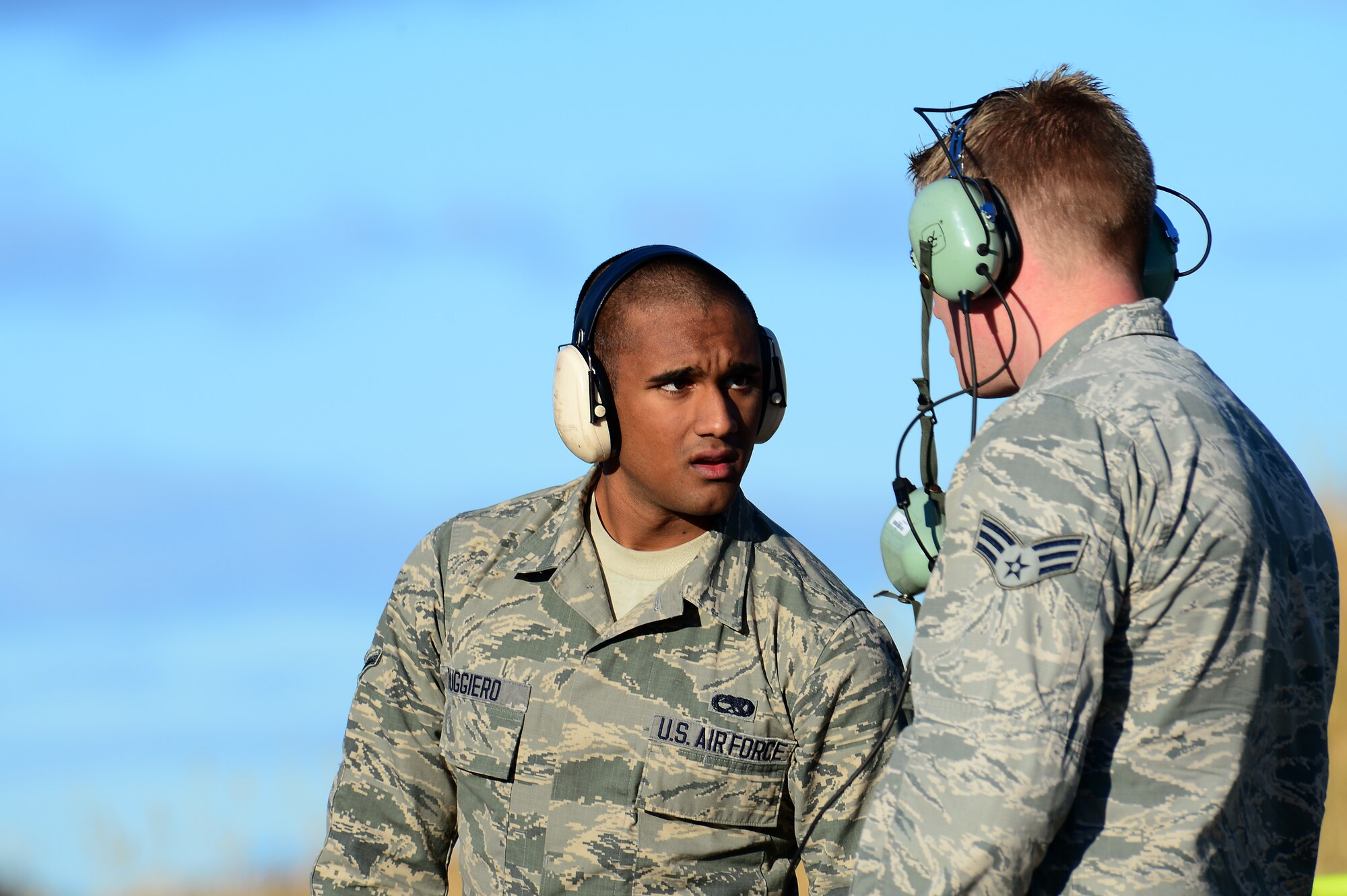 Airman Joseph Ruggiero, 494th Aircraft Maintenance Unit crew chief, talks with Senior Airman Bradley 494th Aircraft Maintenance Unit avionics technician at Bodø Main Air Station, Norway, Sept. 24, 2013. Both were amongst approximately 600 personnel deployed from multiple bases within U.S. Air Forces in Europe-Air Forces Africa, supporting the Arctic Challenge Exercise 2013. ACE-13 was a combined exercise with NATO and regional allies, which promoted continued interoperability between the United States, Norway, Sweden, Finland, United Kingdom and NATO. (U.S. Air Force photo by Master Sgt. Lee Osberry/Released)