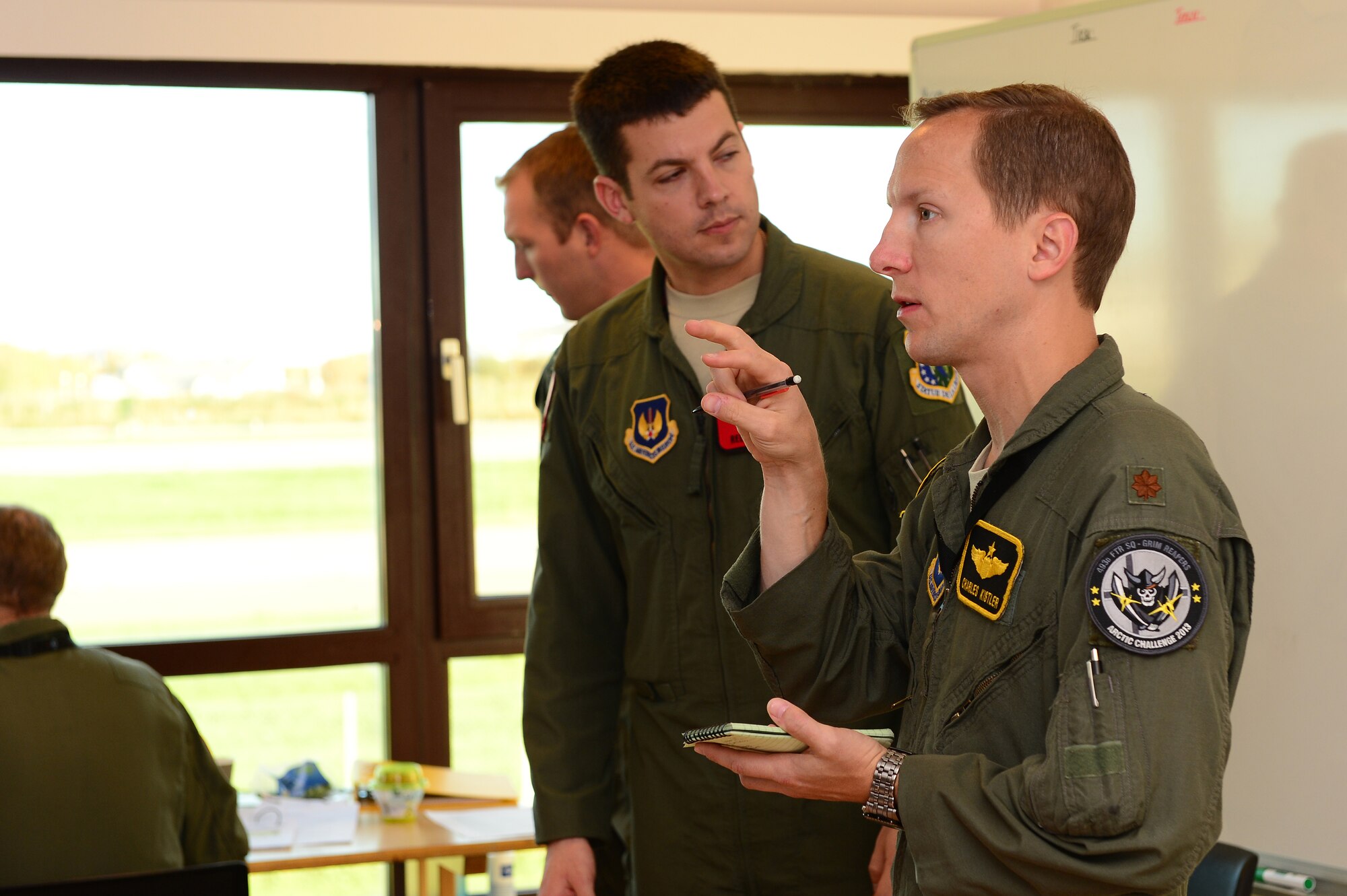 Maj. Charles Kistler, 48th Fighter Wing director of mission readiness, talks with aircrew during a teleconference at Bodø Main Air Station, Norway, Sept. 24, 2013. Kistler was amongst approximately 600 personnel deployed from multiple bases within U.S. Air Forces in Europe-Air Forces Africa, supporting the Arctic Challenge Exercise 2013. ACE-13 was a combined exercise with NATO and regional allies, which promoted continued interoperability between the United States, Norway, Sweden, Finland, United Kingdom and NATO. (U.S. Air Force photo by Master Sgt. Lee Osberry/Released) 