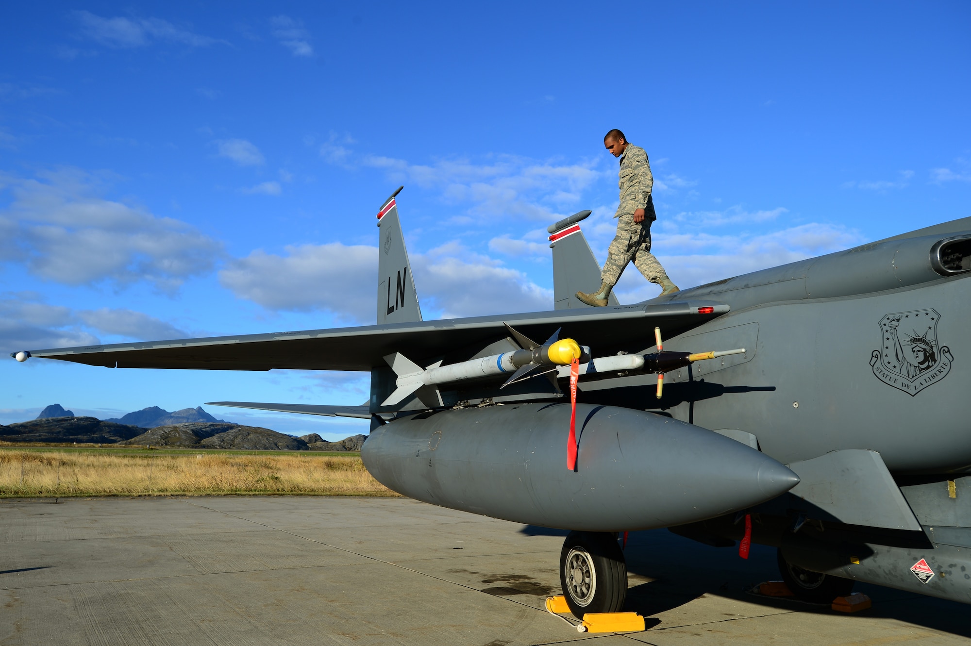 Airman Joseph Ruggiero, 494th Aircraft Maintenance Unit crew chief, inspects the wing of an F-15E Strike Eagle as part of post flight checks at Bodø Main Air Station, Norway, Sept. 24, 2013. Ruggiero was amongst approximately 600 personnel deployed from multiple bases within U.S. Air Forces in Europe-Air Forces Africa, supporting the Arctic Challenge Exercise 2013. ACE-13 was a combined exercise with NATO and regional allies, which promoted continued interoperability between the United States, Norway, Sweden, Finland, United Kingdom and NATO. (U.S. Air Force photo by Master Sgt. Lee Osberry/Released)
