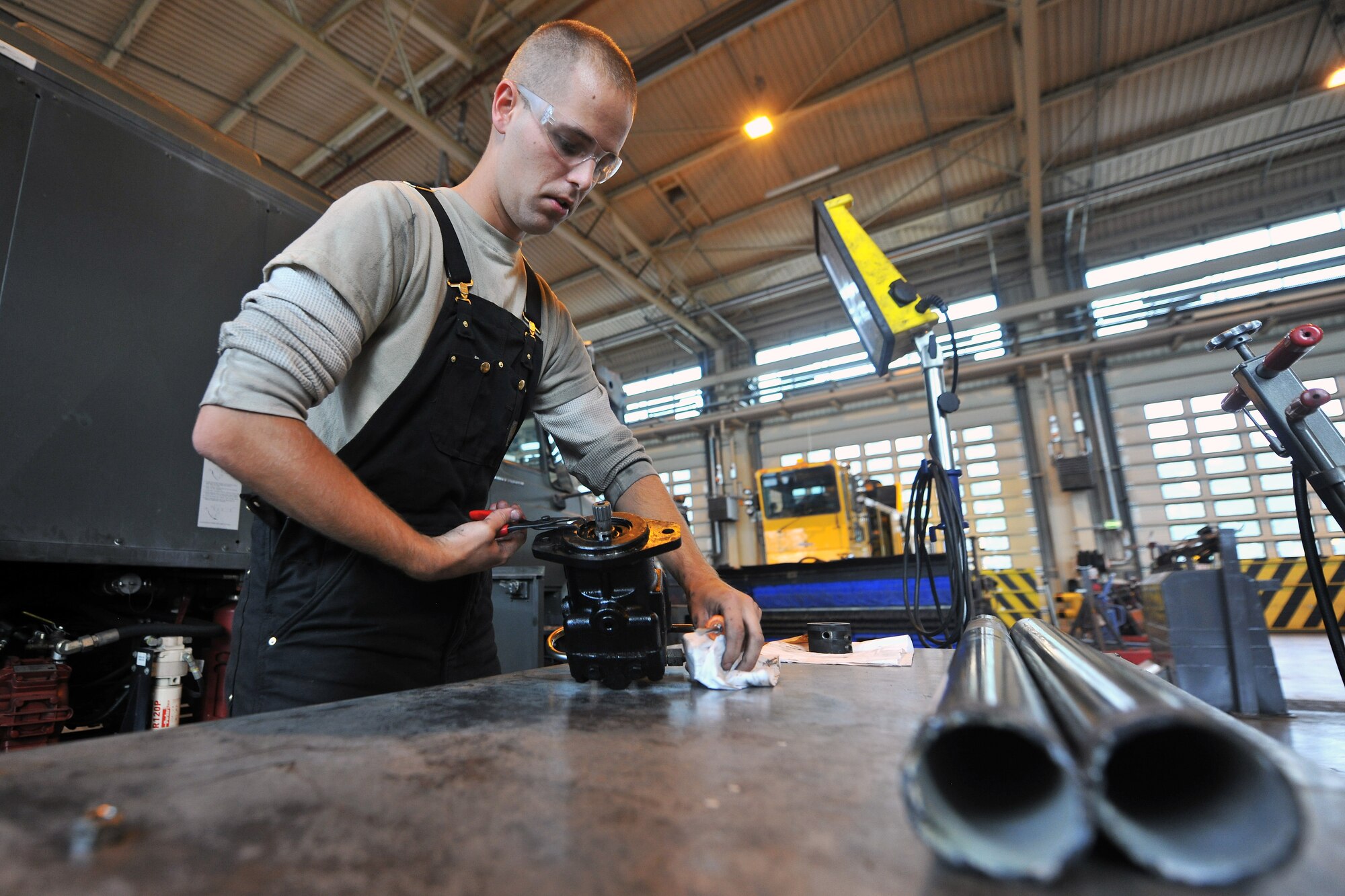 Airman 1st Class Travis Rutherford, 86th Vehicle Readiness Squadron special purpose snow team member, rebuilds a hydraulic motor off of an extended reach deicer Sept. 17, 2013, Ramstein Air Base, Germany. (U.S. Air Force photo/Senior Airman Chris Willis)