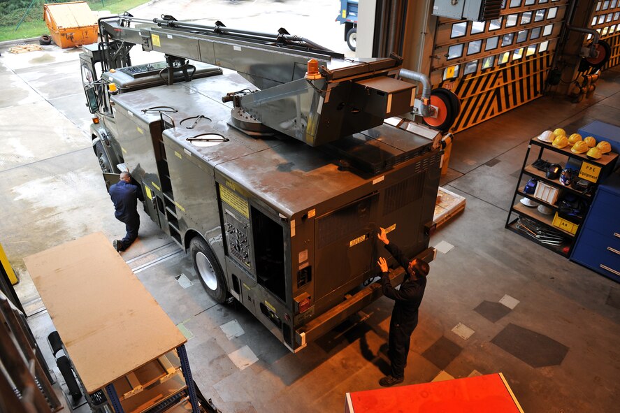 Airman 1st Class Manuel Marquez and Casey Kennedy, 86th Vehicle Readiness Squadron special purpose snow team members, perform repairs and upgrades to a deicer, Sept. 17, 2013, Ramstein Air Base, Germany. The deicer is used during inclement weather to remove ice from aircraft ensuring their safety. (U.S. Air Force photo/Senior Airman Chris Willis)