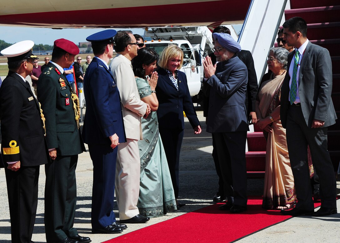 Prime Minister of India Dr. Manmohan Singh greets individuals after arriving at Joint Base, Md., Sept. 26, 2013. The Prime Minister arrived for a two-day visit to meet with President Barack Obama and First Lady Michelle Obama. The Prime Minister was accompanied by his wife Gursharan Kaur and was welcomed by U.S. State Department?s Acting Deputy Chief of Protocol Rosemarie Pauli. (U.S. Air Force photo/Staff Sgt. Nichelle Anderson)