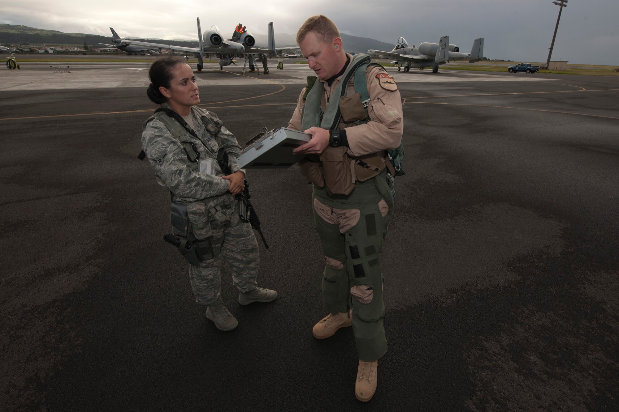 U.S. Air Force Airman Danielle Villafane, 65th Security Forces Squadron defender, talks with Capt. John Lowe, 75th Fighter Squadron A-10 Thunderbolt pilot, about any requirements that might be needed Sept. 24, 2013, at Lajes Field, Azores. Villafane is a Broken Arrow, Okla. native. (U.S. Air Force photo by Tech. Sgt. Paul Villanueva II/Released)