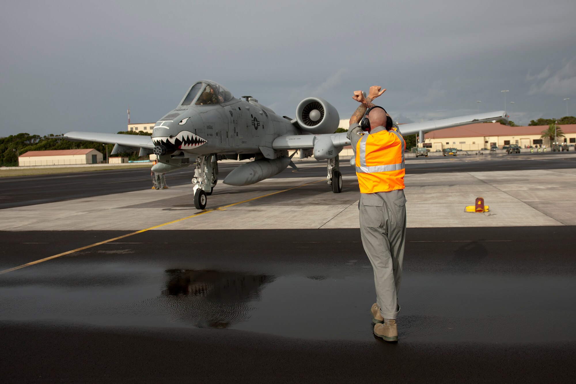 U.S. Air Force Tech. Sgt. Luke Adams, 65th Operations Support Squadron F-16 crew chief and coronet liaison, marshals an A-10 Thunderbolt II into a parking stall Sept, 24, 2013, at Lajes Field, Azores. As a coronet liaison, Adams is in charge of all fighter aircraft that fly in and out of Lajes Field. He ensures all post operational checks are performed to keep the aircraft operational. (U.S. Air Force photo by Tech. Sgt. Paul Villanueva II/Released)