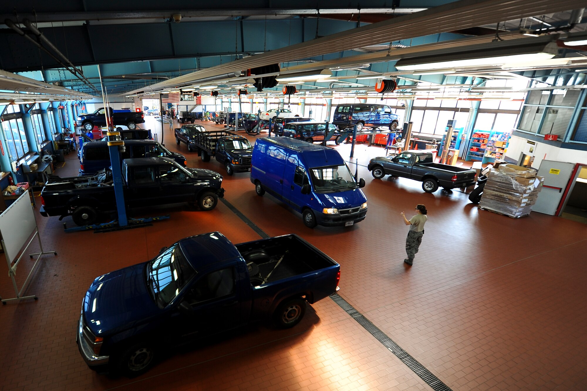 SPANGDAHLEM AIR BASE, Germany--Airmen of the 52nd Logistics Readiness Squadron vehicle maintenance shop work on government-owned vehicles at their squadron’s garage Sept. 24, 2013. Members of the 52nd LRS vehicle maintenance shop prepare, provide and deploy vehicles and mechanics. (U.S. Air Force photo by Senior Airman Rusty Frank/Released)