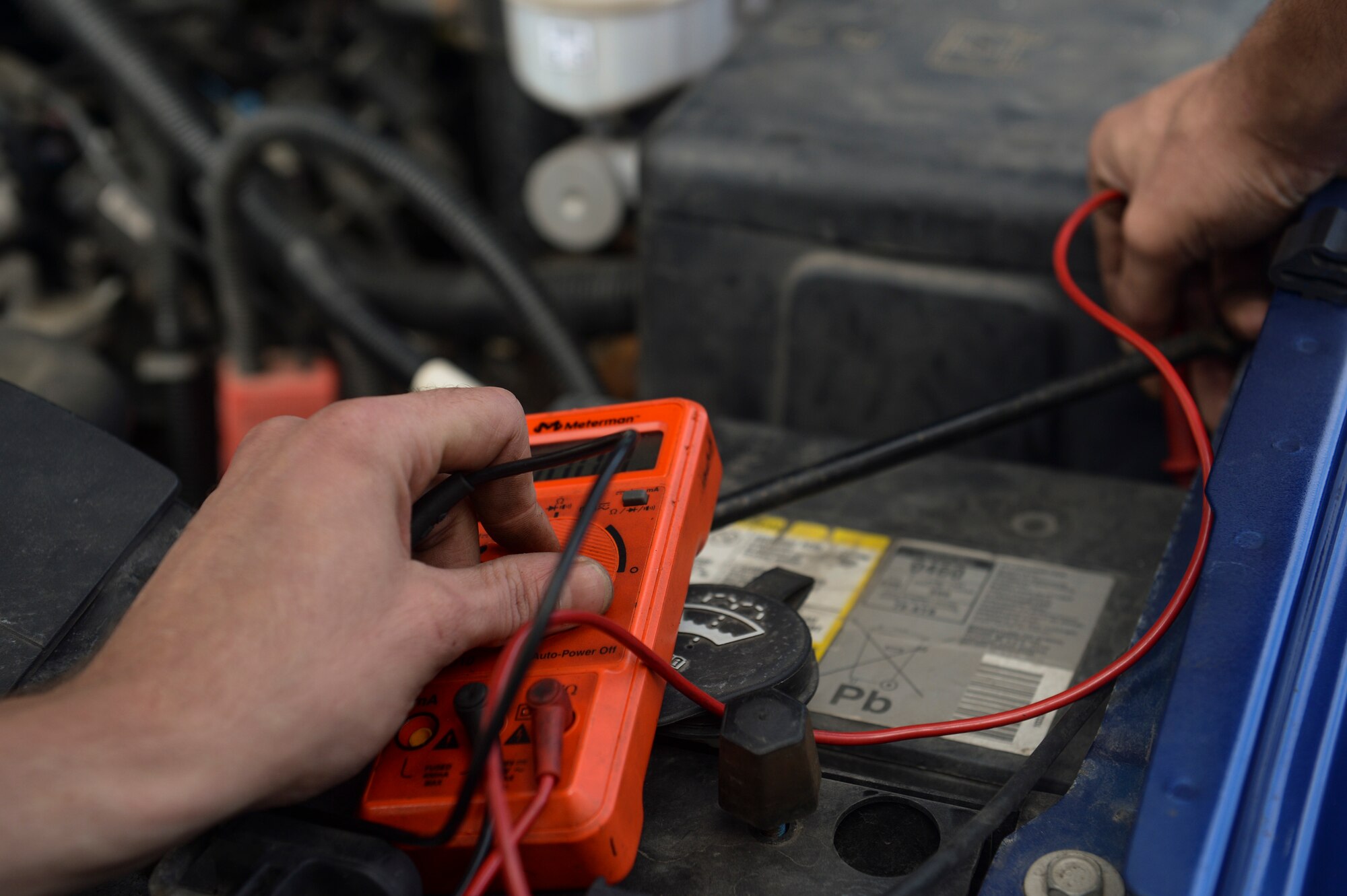 SPANGDAHLEM AIR BASE, Germany--Staff Sgt. Randy Johnson, 52nd Logistics Readiness Squadron vehicle maintenance technician from New Ark, Ohio, uses a multi-meter to check the voltage on a car’s alternator at the vehicle maintenance shop Sept. 23, 2013. By using the multi-meter to check the voltage, Johnson ensured the alternator was properly charging the battery. (U.S. Air Force photo by Senior Airman Rusty Frank/Released)