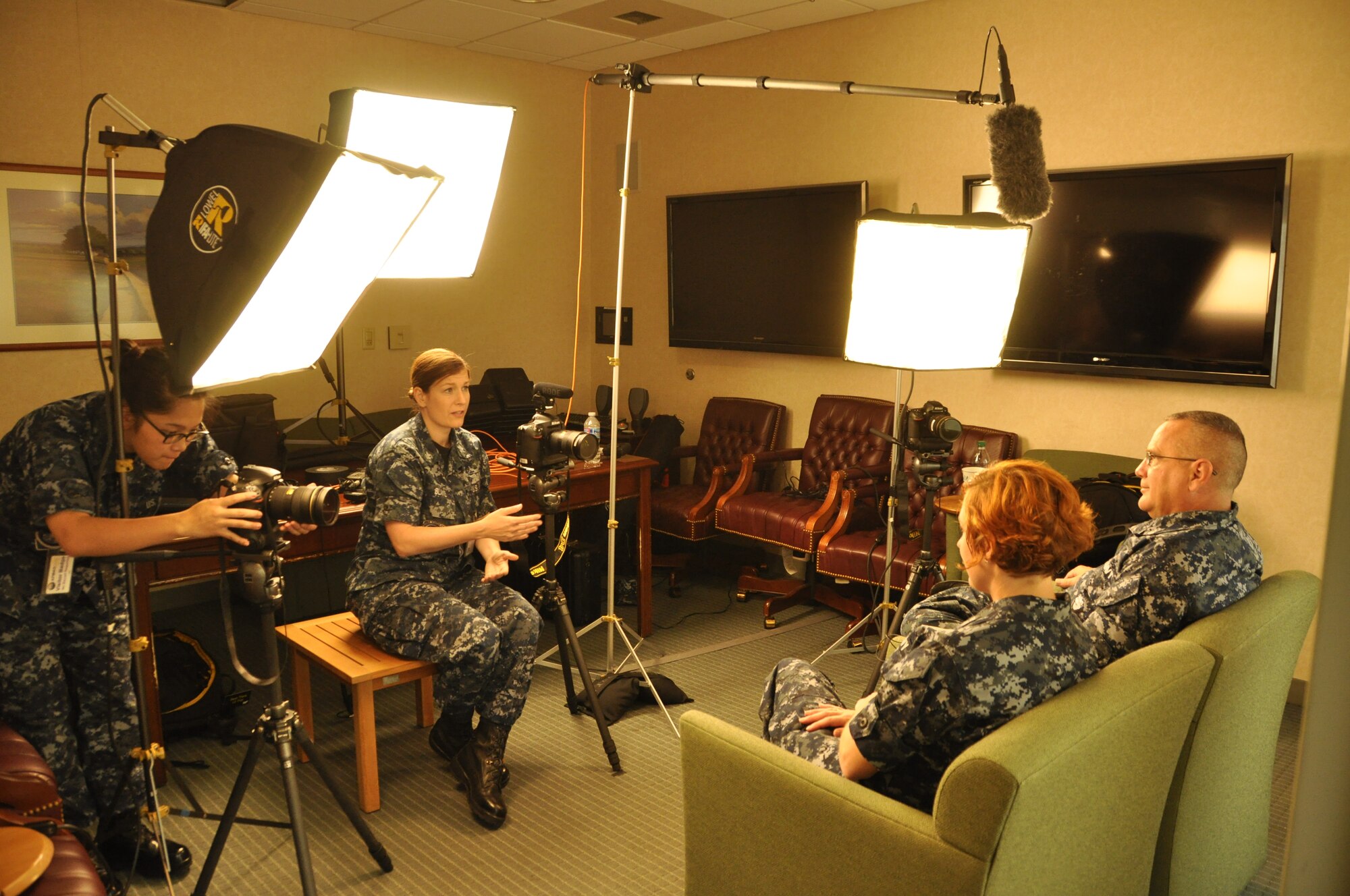 Mass Communication Specialist Seaman Jennifer Lebron and Mass Communication Specialist 1st Class Jen Blake interview Hospital Corpsman 1st Class Jennifer Heiselman and Hospital Corpsman 1st Class Whit Sloane Aug. 14, 2013 at the Charles C. Carson Center for Mortuary Affairs, Dover Air Force Base, Del. Lebron and Blake, assigned to Defense Media Activity, Fort Meade, Md., were highlighting the work of the Navy liaisons who support the mortuary mission and care for fallen sailors and their families. The liaisons are two of only 12 licensed funeral directors in the Navy. (U.S. Air Force photo/Christin Michaud)