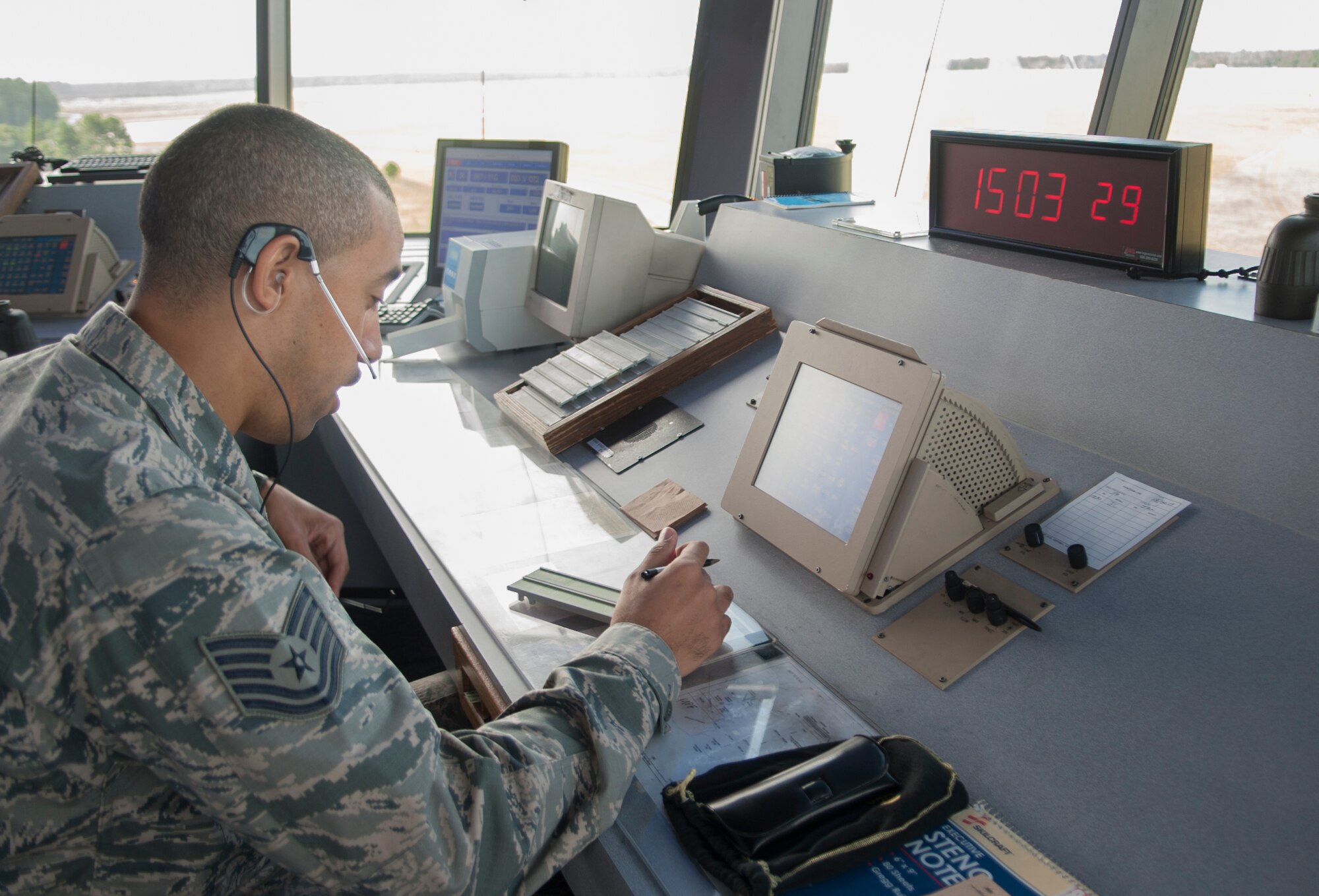 U.S. Air Force Tech. Sgt Joshua Lynch, 23d Operations Support Squadron air traffic control journeyman, updates the Automatic Terminal Information Service at Moody Air Force Base, Ga., Sept. 19, 2013. Pilots use the service to listen to information about temperature, cloud level, and airfield conditions. (U.S. Air Force photo by Airman 1st Class Sandra Marrero/Released)
