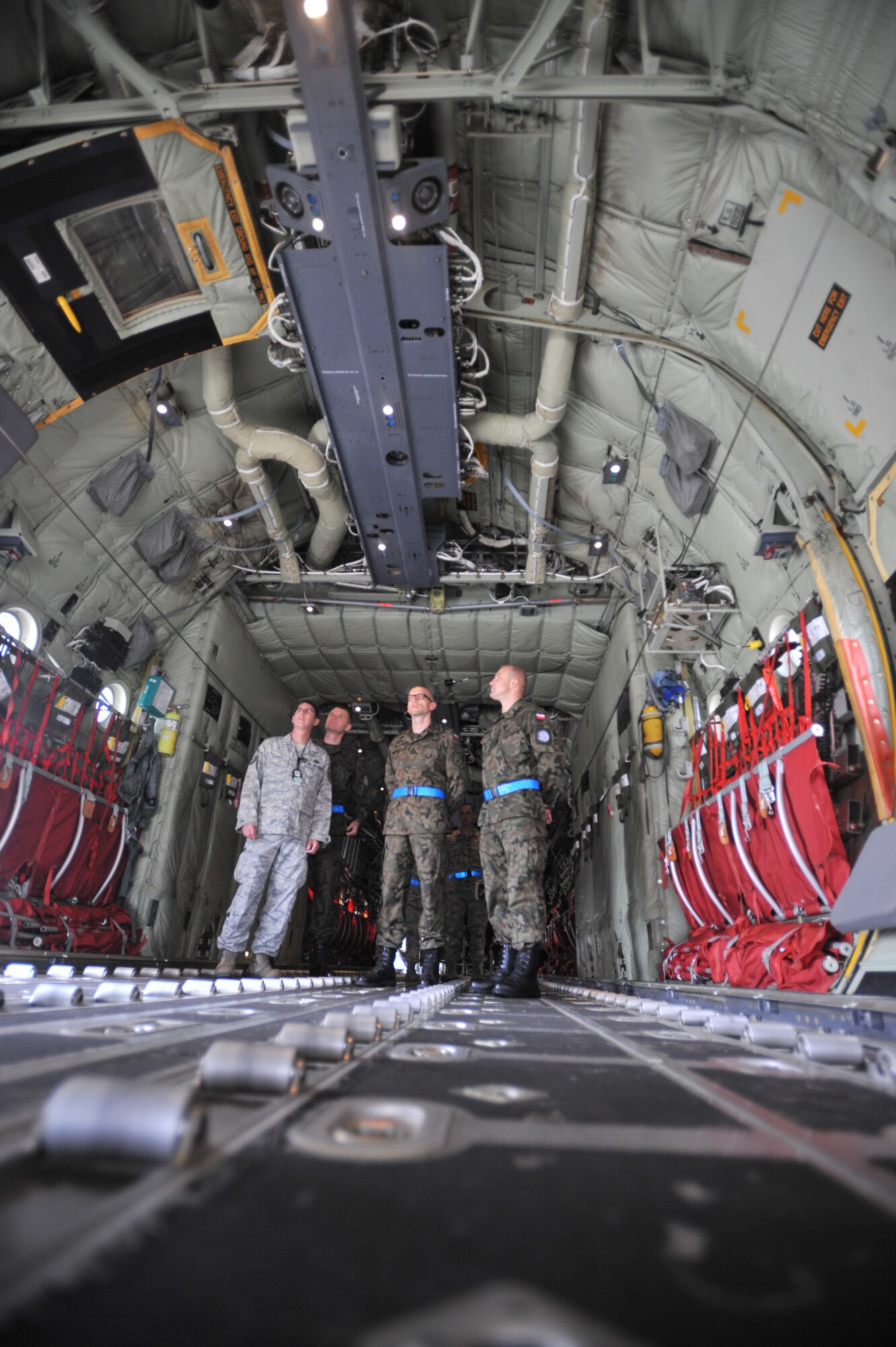 Master Sgt. Jason Carey, 86th Aircraft Maintenance Squadron production superintendent, explains the multiple functions of the C-130J Super Hercules to Warrant Officer 1st Class Krzysztof Gadowski and his staff, Sept. 18, 2013, Ramstein Air Base, Germany. The visit gave WO1 Gadowski and his team a chance to further military relations and improve military education operations. (U.S. Air Force photo/Senior Airman Aaron-Forrest Wainwright)