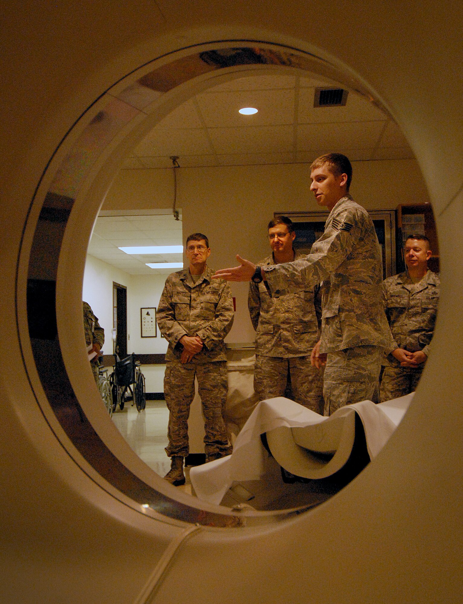 Staff Sgt. Matthew Stroud, 51st Medical Operations Squadron Computed Tomography scan technician, briefs base leadership during a Mustang Immersion tour at Osan Air Base, Republic of Korea, Sept. 26, 2013. The Mustang Immersion tour aimed to promote cohesion among members of Team Osan. (U.S. Air Force photo/1st Lt. Kay M. Nissen)