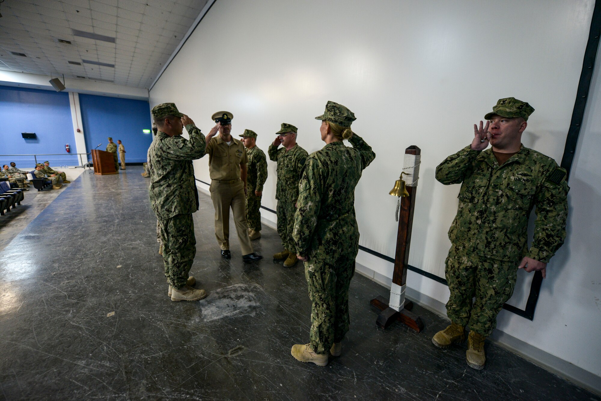 Newly pinned Chief Petty Officer, Timothy Spicer for the first time salutes as a chief after being piped into the chief petty officer’s mess during the CPO ceremony at the 379th Air Expeditionary Wing in Southwest Asia, Sept. 21, 2013. Rich in traditions and rituals, which guide much of Navy life, the chief petty officer pinning ceremony is preserved to ensure Sailors stay consistent with the Navy’s core values of honor, courage and commitment. Spicer is a logistic specialist assigned to the Expeditionary Warfare-Fleet Marine Forces, hometown Rogers, Mn., and deployed from the Navy Air Cargo Handling Battalion 7, Great Lakes, Il. (U.S. Air Force photo/Tech. Sgt. Joselito Aribuabo) 