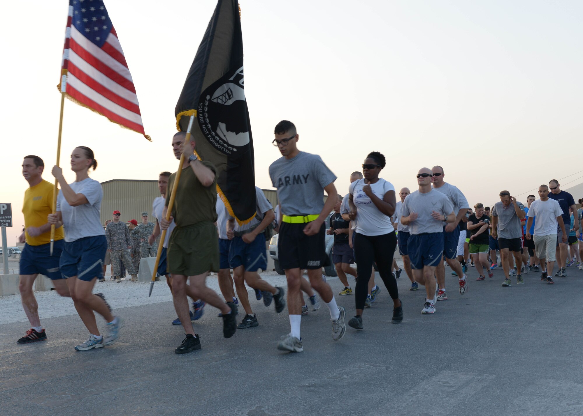 Deployed service members participate in a prisoner of war and missing in action 5K run at the 379th Air Expeditionary Wing in Southwest Asia, Sept. 20, 2013. The United States League of Families POW/MIA flag remained in constant motion traveling 960 miles, symbolizing the commitment of the U.S. people, armed forces and government to never forget the sacrifices POW/MIAs have made. (U.S. Air Force photo/Senior Airman Bahja J. Jones) 

