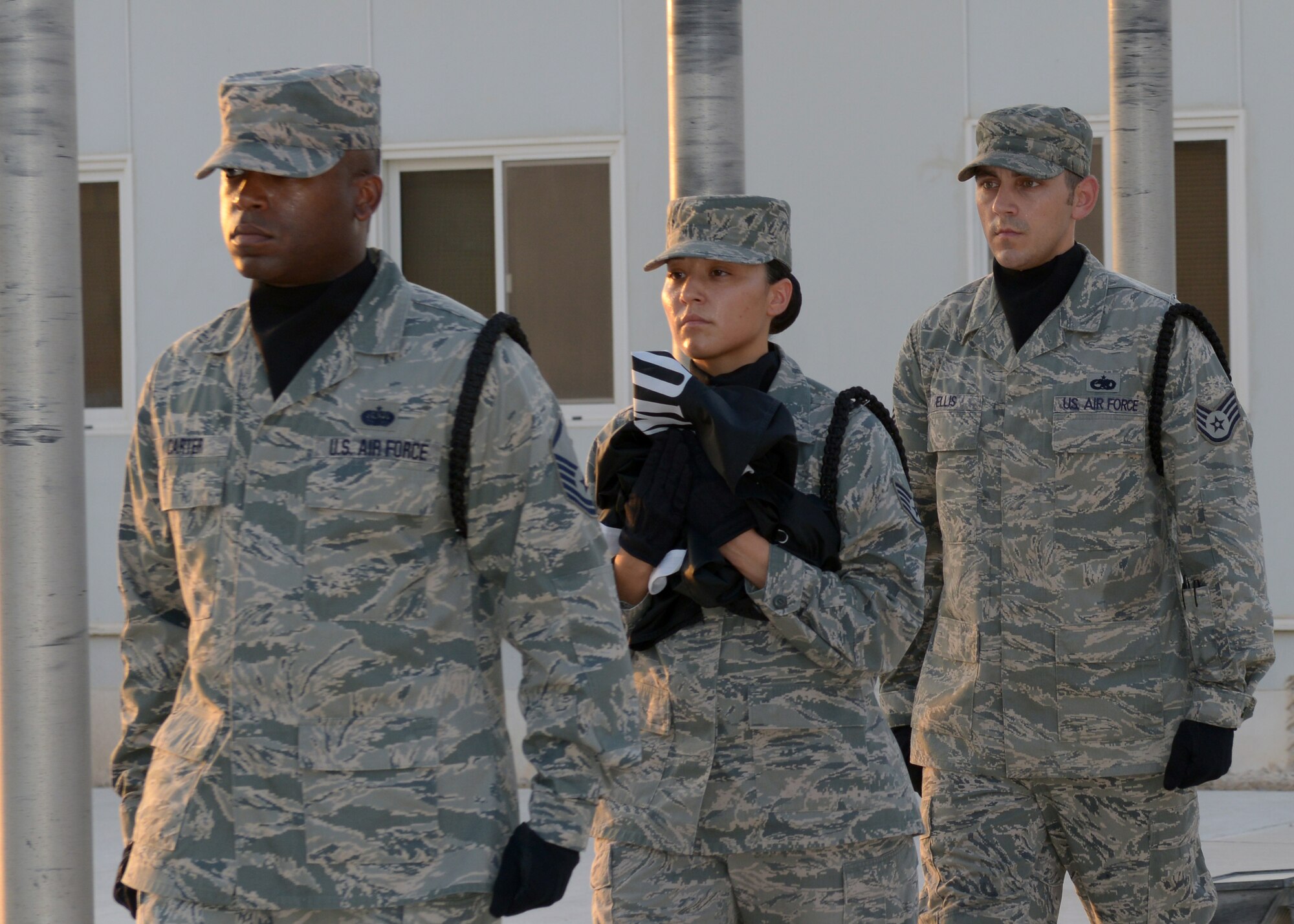 Grand Slam honor guardsmen carry the U.S. League of Families prisoner of war and missing in action flag before raising it over a memorial at the 379th Air Expeditionary Wing in Southwest Asia, Sept. 20, 2013. The league’s flag has been flown over the White House on National POW/MIA Recognition Day since 1982 as a symbol of commitment to those who are still prisoners of war and missing in action. (U.S. Air Force photo/Senior Airman Bahja J. Jones) 

