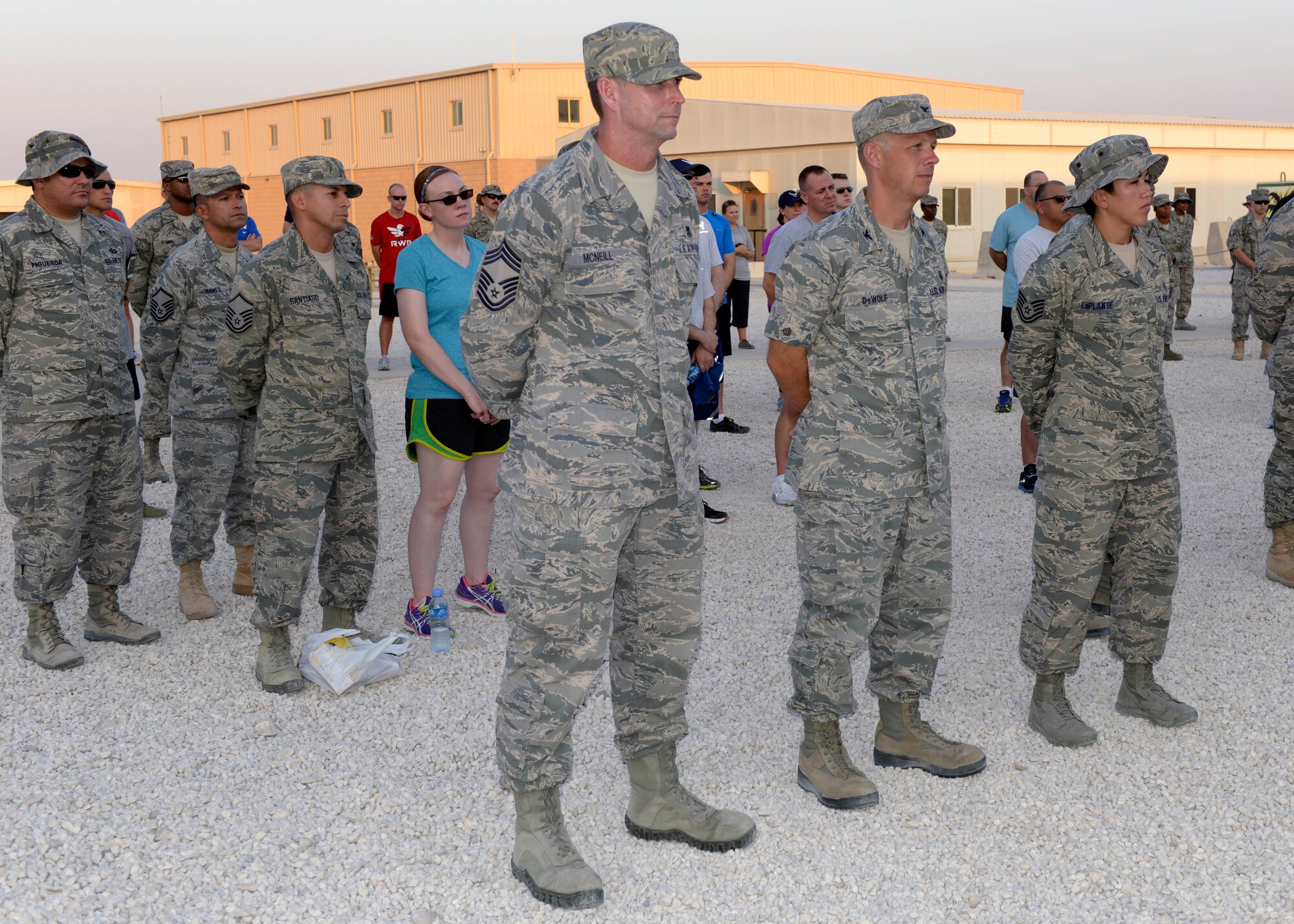 Service members gather for a prisoner of war and missing in action remembrance ceremony at the 379th Air Expeditionary Wing in Southwest Asia, Sept. 20, 2013. Every year on the third Friday in September, military installations and ships, schools and churches throughout the nation pay tribute to honor the commitment and sacrifices of prisoners of war as well as those who are still missing in action. (U.S. Air Force photo/Senior Airman Bahja J. Jones) 
