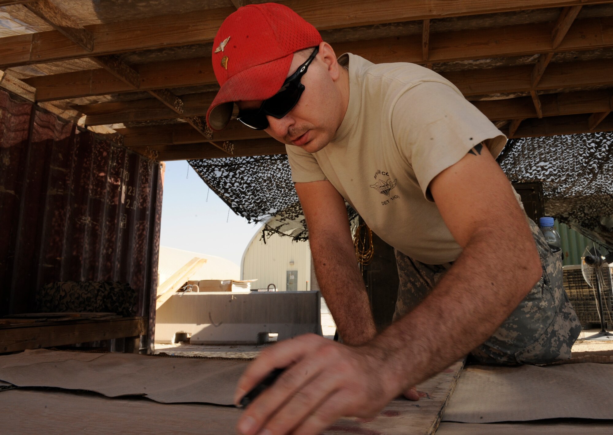 U.S. Army Spc. Steven Payne uses a straight edge to draw a line on energy dissipating material before cutting through it at the 379th Air Expeditionary Wing in Southwest Asia, Sept. 23, 2013. The cardboard-like material is used to absorb the impact when barrels are airdropped to troops down range. Payne is a 861st Quartermaster Company Detachment 1 airdrop specialist deployed from William F. Lyell Armed Forces Reserve Center, Tenn., and a Frankfort, Ky., native. (U.S. Air Force photo/Senior Airman Bahja J. Jones) 



