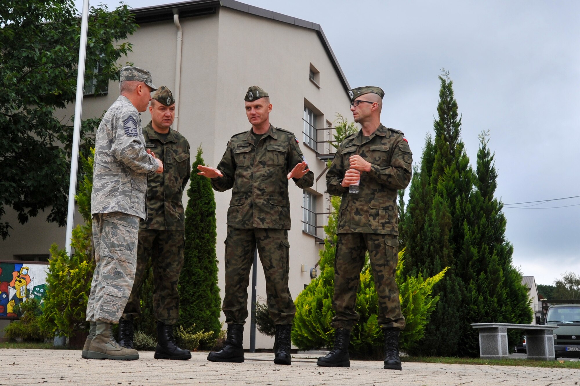 Chief Master Sgt. Christopher Moore, Kisling Noncommissioned Officer Academy commandant, gives a tour to Warrant Officer 1st Class Krzysztof Gadowski and his staff Sept. 17, 2013, at Kapaun Air Station, Germany.  The visit gave the Polish senior NCO leaders a chance to further military relations and improve military education programs for Polish airmen. (U.S. Air Force photo/Senior Airman Aaron-Forrest Wainwright)