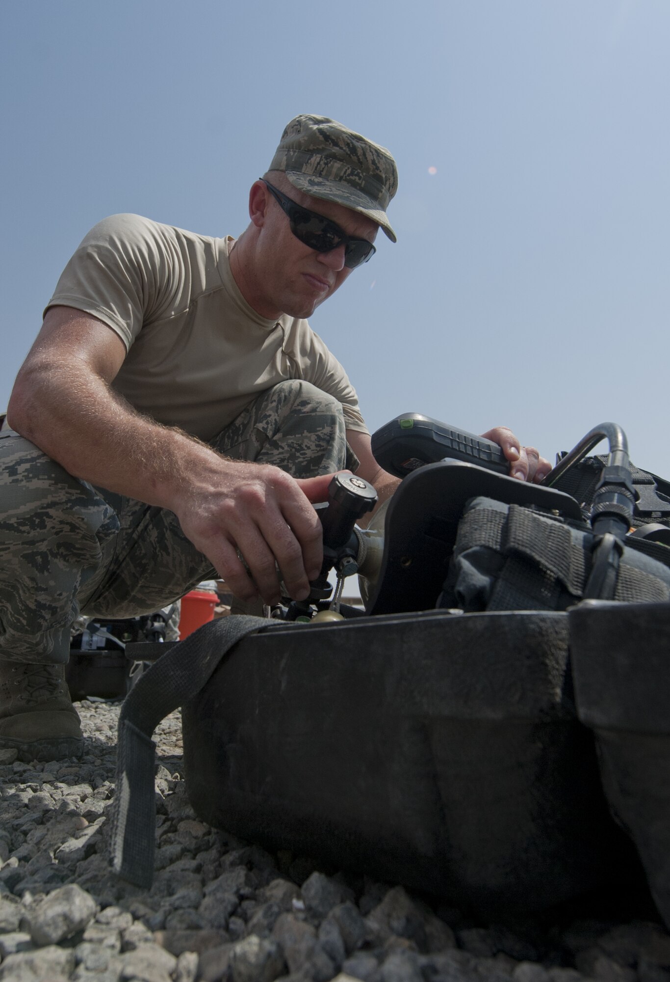 U.S. Air Force Staff Sgt. Russell Woolstenhulme, 380th Expeditionary Civil Engineer Squadron emergency management craftsman, prepares his self-contained breathing apparatus on the scene of an exercise chemical threat area at an undisclosed location in Southwest Asia Sept. 20, 2013. When a chemical threat is suspected, emergency management personnel will wear the SCBA for safety. Woolstenhulme calls Price, Utah, home and is deployed from Hurlburt Field, Fla. (U.S. Air Force photo by Staff Sgt. Jacob Morgan)