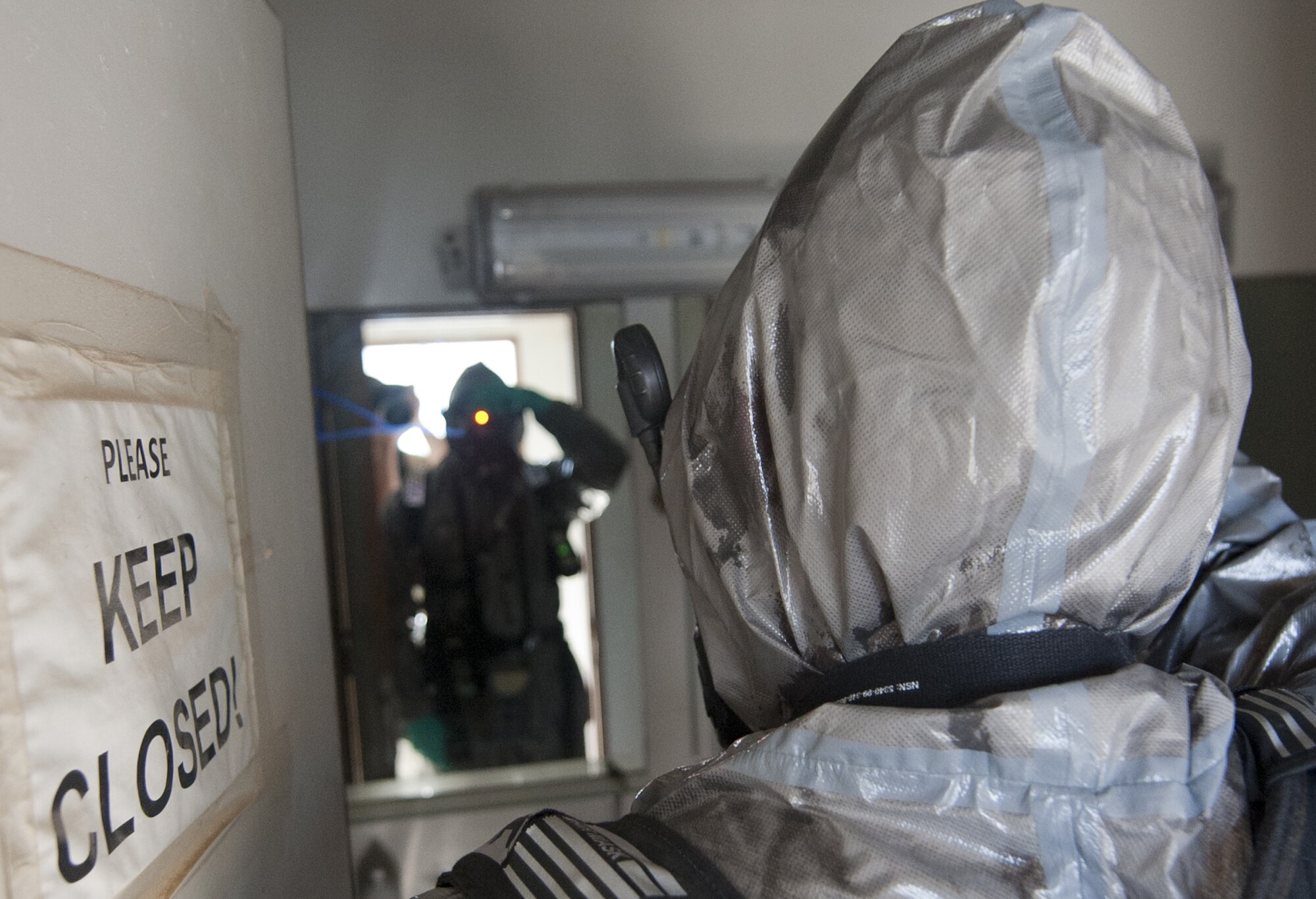 U.S. Air Force Senior Airman Jeremy Harrison, 380th Expeditionary Civil Engineer Squadron emergency management journeyman, takes photos of an exercise hazardous chemical crime scene at an undisclosed location in Southwest Asia Sept. 20, 2013. Emergency management personnel take pictures to document the scene to give the incident commander more situational awareness. Harrison calls Houston, Texas, home and is deployed from Ellsworth Air Force Base, S.D. (U.S. Air Force photo by Staff Sgt. Jacob Morgan)