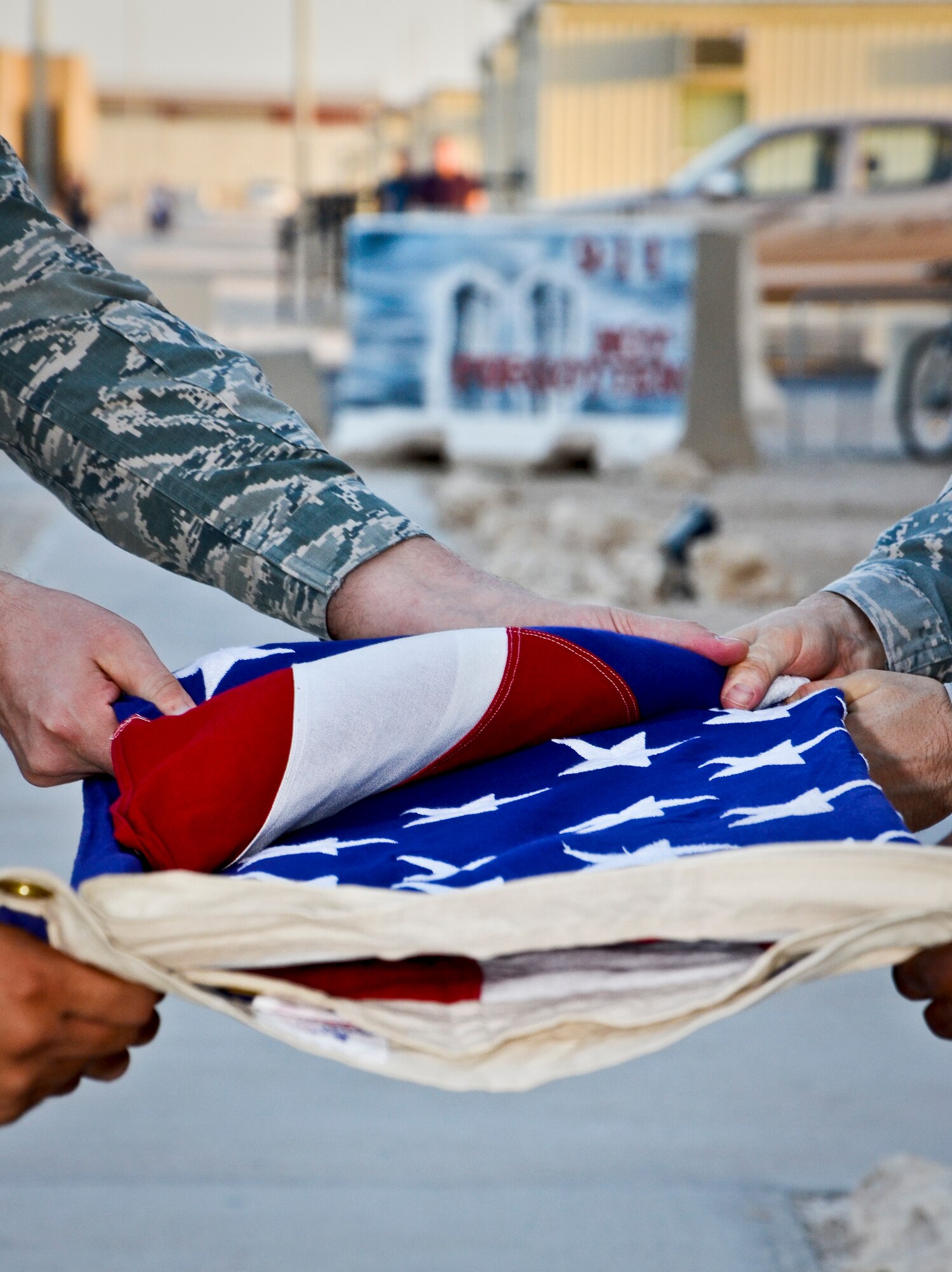 Members of the base honor guard fold the American flag during a prisoners of war and missing in action remembrance ceremony at the 379th Air Expeditionary Wing in Southwest Asia, Sept. 21, 2013. In the United States, National POW/MIA Recognition Day is observed on the third Friday in September and honors those who were prisoners of war and those who are still missing in action. The day was established by an Act of Congress and is one of six days the POW/MIA flag can be flown. (U.S. Air Force photo/Staff Sgt. Benjamin W. Stratton)