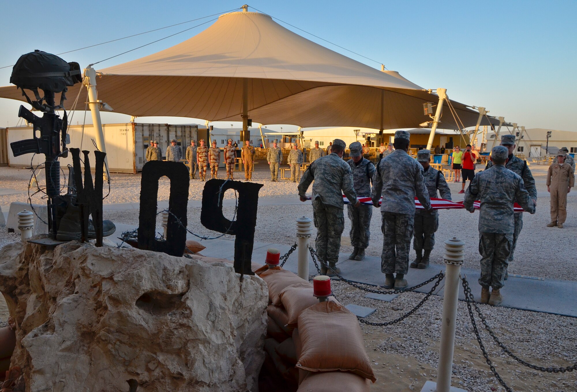 Members of the base honor guard fold the American flag as U.S. military, coalition and mission partners observe during a prisoners of war and missing in action remembrance ceremony at the 379th Air Expeditionary Wing in Southwest Asia, Sept. 21, 2013. In the United States, National POW/MIA Recognition Day is observed on the third Friday in September and honors those who were prisoners of war and those who are still missing in action. The day was established by an Act of Congress and is one of six days the POW/MIA flag can be flown. (U.S. Air Force photo/Staff Sgt. Benjamin W. Stratton)