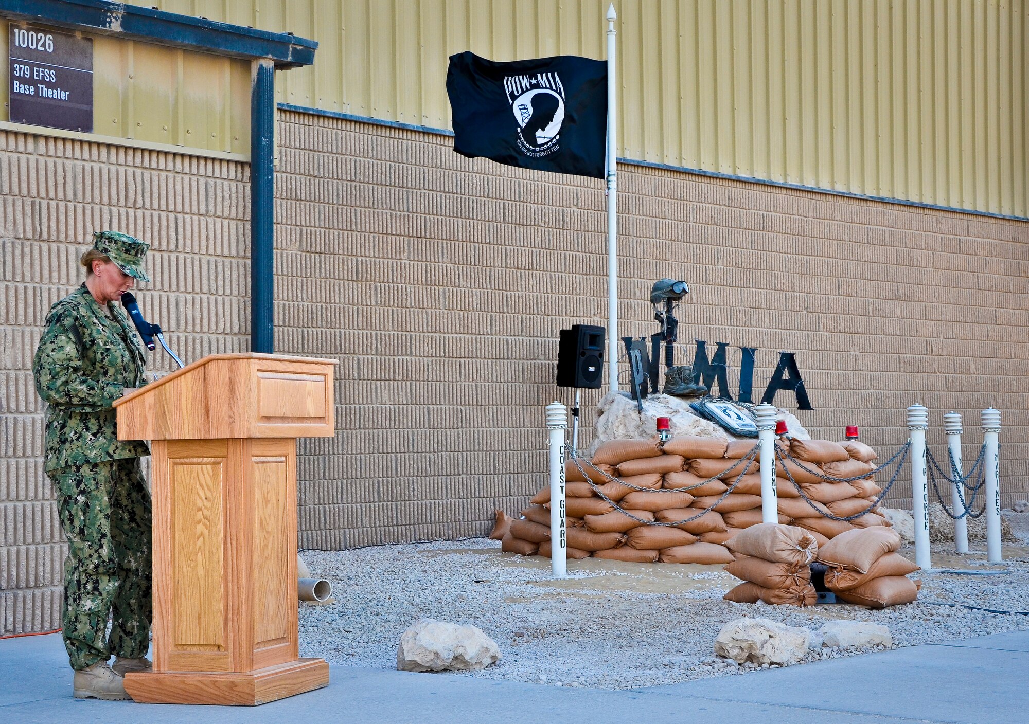 Senior Chief Petty Officer Laura Johnston addresses those in attendance at the base’s prisoners of war and missing in action 24-hour vigil run closing ceremony at the 379th Air Expeditionary Wing in Southwest Asia, Sept. 21, 2013. The run began Sept. 20 and culminated with a closing ceremony and traditional flag folding by the base honor guard in reverence to those still missing. Johnston is the Combined Air and Space Operations Center Naval and Amphibious Liaison Element leading senior chief petty officer deployed from Fort George G. Meade, Md., and hails from Oklahoma City, Okla. (U.S. Air Force photo/Staff Sgt. Benjamin W. Stratton)