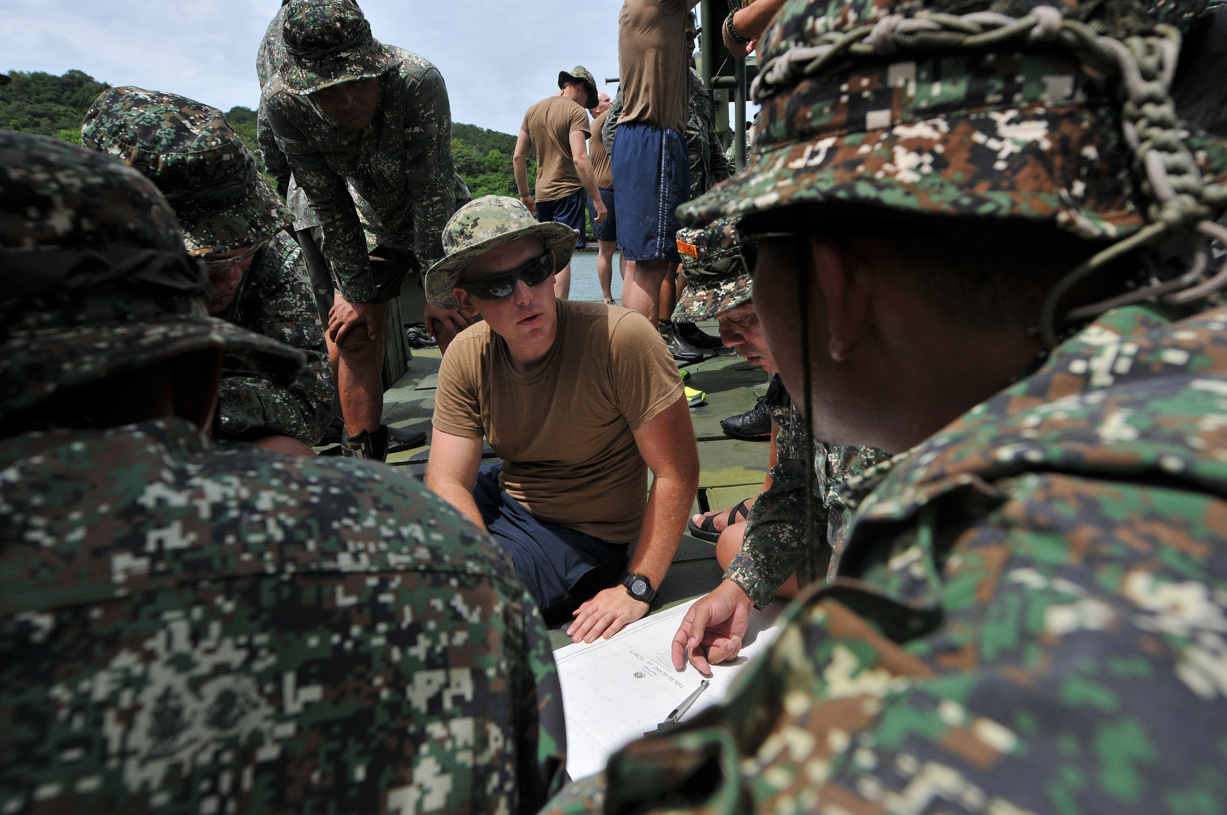 U.S. Navy Petty Officer 3rd Class Matthew Mitchell conducts navigation