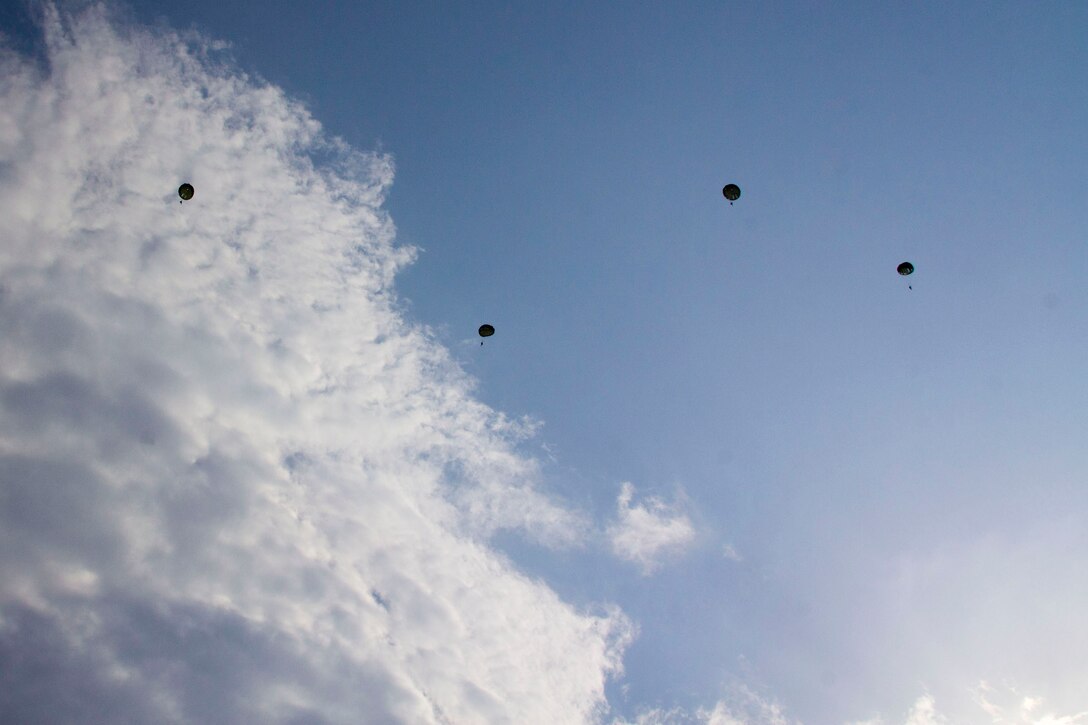 U.S. Marines assigned to Reconnaissance Platoon, Battalion Landing Team (BLT) 3/2, 26th Marine Expeditionary Unit (MEU), conduct static line parachute operations over Djibouti, Africa, Sept. 23, 2013. The 26th MEU is a Marine Air-Ground Task Force forward-deployed to the U.S. 5th and 6th Fleet areas of responsibility aboard the Kearsarge Amphibious Ready Group serving as a sea-based, expeditionary crisis response force capable of conducting amphibious operations across the full range of military operations. (U.S. Marine Corps photo by Cpl. Kyle N. Runnels/Released)