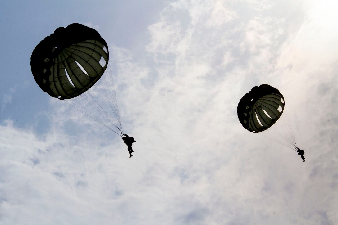 U.S. Marines assigned to Reconnaissance Platoon, Battalion Landing Team (BLT) 3/2, 26th Marine Expeditionary Unit (MEU), conduct static line parachute operations over Djibouti, Africa, Sept. 23, 2013. The 26th MEU is a Marine Air-Ground Task Force forward-deployed to the U.S. 5th and 6th Fleet areas of responsibility aboard the Kearsarge Amphibious Ready Group serving as a sea-based, expeditionary crisis response force capable of conducting amphibious operations across the full range of military operations. (U.S. Marine Corps photo by Cpl. Kyle N. Runnels/Released)