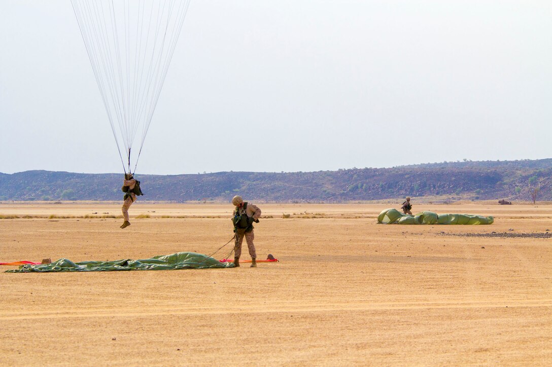 U.S. Marines assigned to Reconnaissance Platoon, Battalion Landing Team (BLT) 3/2, 26th Marine Expeditionary Unit (MEU), conduct static line parachute operations over Djibouti, Africa, Sept. 23, 2013. The 26th MEU is a Marine Air-Ground Task Force forward-deployed to the U.S. 5th and 6th Fleet areas of responsibility aboard the Kearsarge Amphibious Ready Group serving as a sea-based, expeditionary crisis response force capable of conducting amphibious operations across the full range of military operations. (U.S. Marine Corps photo by Cpl. Kyle N. Runnels/Released)