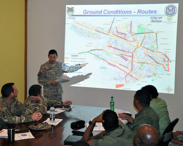 U.S. Army Lt. Col. Alan McKewan, Joint Task Force-Bravo Central America Survey and Assessment Team lead, presents a scenario during a disaster response exercise in Belize, Sept. 27, 2013.  The C-SAT team participated in an international disaster response exercise in order to increase the team's ability to coordinate with other military and disaster response entities to alleviate human suffering in a real world event.  (U.S. Air Force photo by Capt. Zach Anderson)