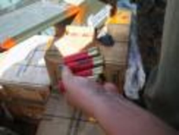 A Marine examines 12-gauge shotgun shells during a field ammunition supply point exercise Sept. 18 at Landing Zone Dodo in the Central Training Area. The Marine is with Ammunition Co.


