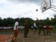 Petty Officer 2nd Class Neil C. Domingo, left, watches as Petty Officer 2nd Class Kahealani W. Aipia tries to block a Taysan Elementary School student’s shot during a game Sept. 23 at Taysan Elementary School, Legazpi City, Albay, Republic of the Philippines. The sailors are participating in Amphibious Landing Exercise 2014, a Philippine-U.S. exercise designed to improve interoperability, increase readiness and enhance the ability for a bilateral force to respond to natural disasters or other regional contingencies. Aipia and Domingo are hospital corpsmen with 3rd Medical Battalion, 3rd Marine Logistics Group, III Marine Expeditionary Force.