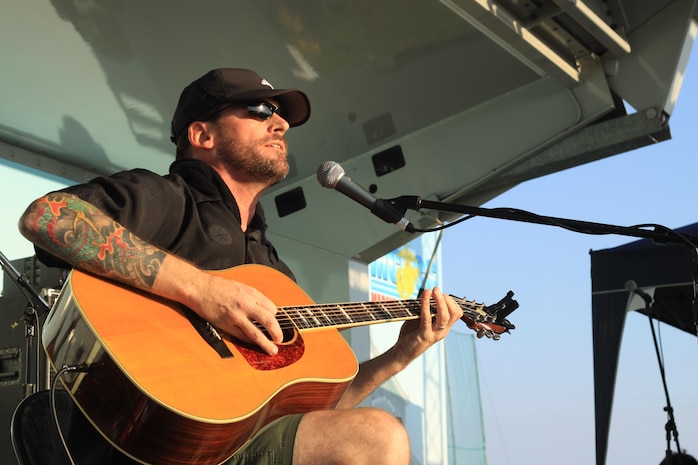 Jimmy Stare, a musician and retired Marine, performs during the 2013 Summer Music Festival that took place at the Penny Lake fields aboard Marine Corps Air Station Iwakuni, Japan, Sept. 21, 2013. Page took time after his stage performance to pass out free CDs and other gifts to fans.