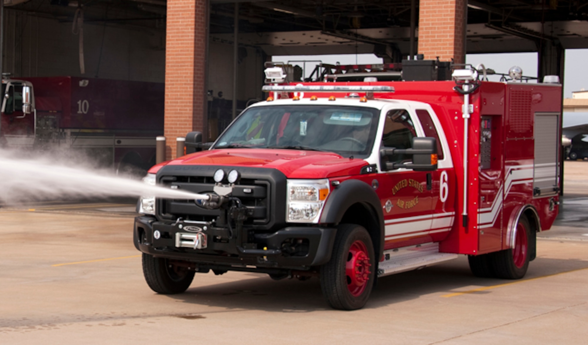 Firefighter Carl Lamb demonstrates the ultra high pressure turret mounted on the front of the bumper of a P-34 Rapid Intervention Vehicle (RIV) July 12, 2012 at Sheppard Air Force Base, Texas. The P 34 is the newest addition to the Air Force crash response fleet.