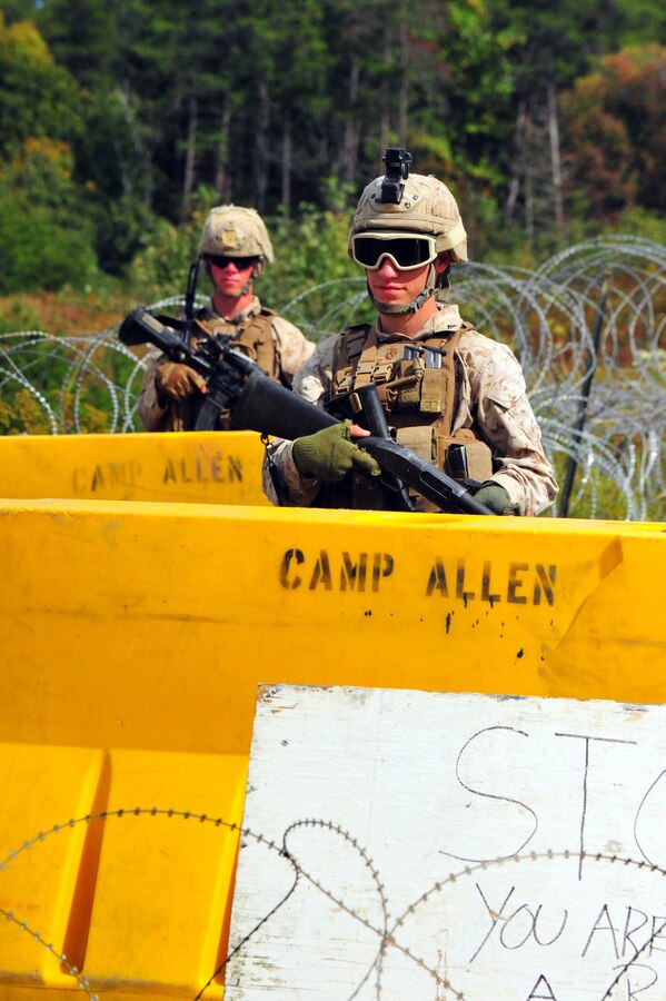 Lance Cpl. Bradley Sather, rifleman, and Lance Cpl. Bradley Easterly, Infantry Automatic Rifle gunner, stand post during a training exercise at the Urban Training Center aboard Marine Corps Base Quantico on Sept. 25, 2013. The two Marines are part of a Fleet Anti- Terrorism Security Team from Norfolk, Va., who were preparing for a seven-month deployment. 