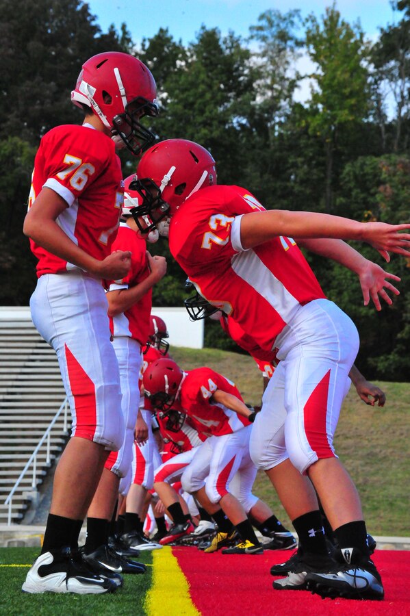 The Quantico Warriors varsity football team runs drills while preparing for a game against the Randolph-Macon Academy Yellowjackets from Front Royal, Va., at Butler Stadium on Sept. 23, 2013. The Warriors lost 40-7. (Marine Corps photo by Lance Cpl. Samuel Ellis/Released)