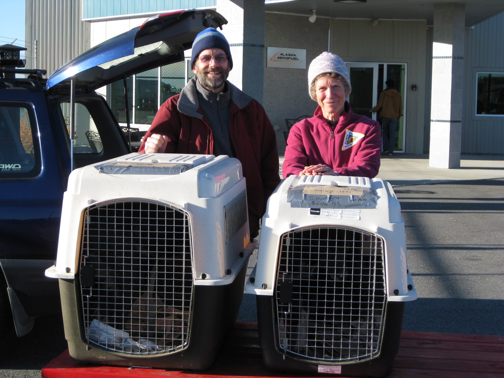 Members of the non-profit sled dog rescue “Second Chance League” pose with Cruger and Tiny as they prepare to fly out of Fairbanks Airport on September 16. 