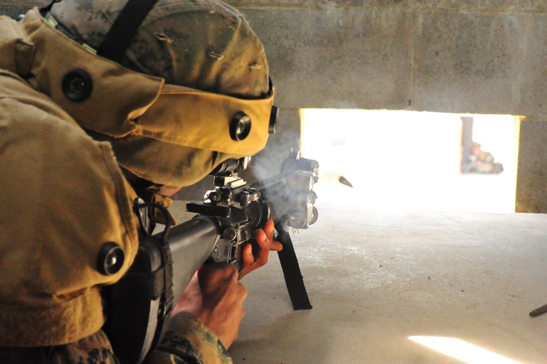 Second Lt. David Hunter fires at an opponent during a training exercise at the Military Operations Urban Terrain Town at Marine Corps Base Quantico on Sept. 25, 2013. Almost 300 Charlie Co. Marines participated in the event.