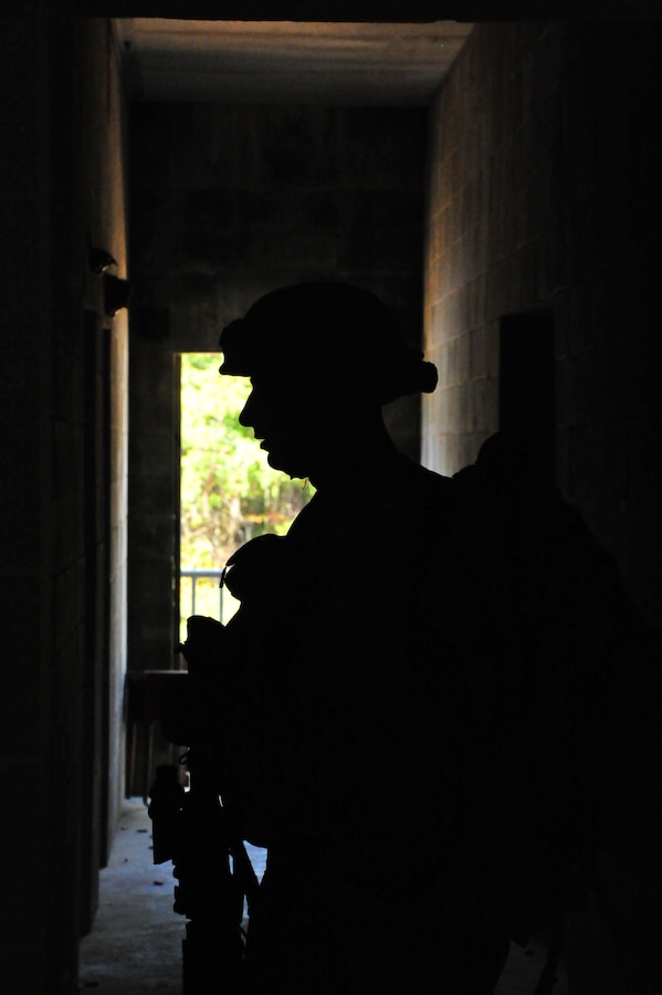 A Marine walks through a hallway during an urban combat training exercise at the Military Operations Urban Terrain Town at Marine Corps Base Quantico on Sept. 25, 2013. Almost 300 Charlie Co. Marines participated in the event.