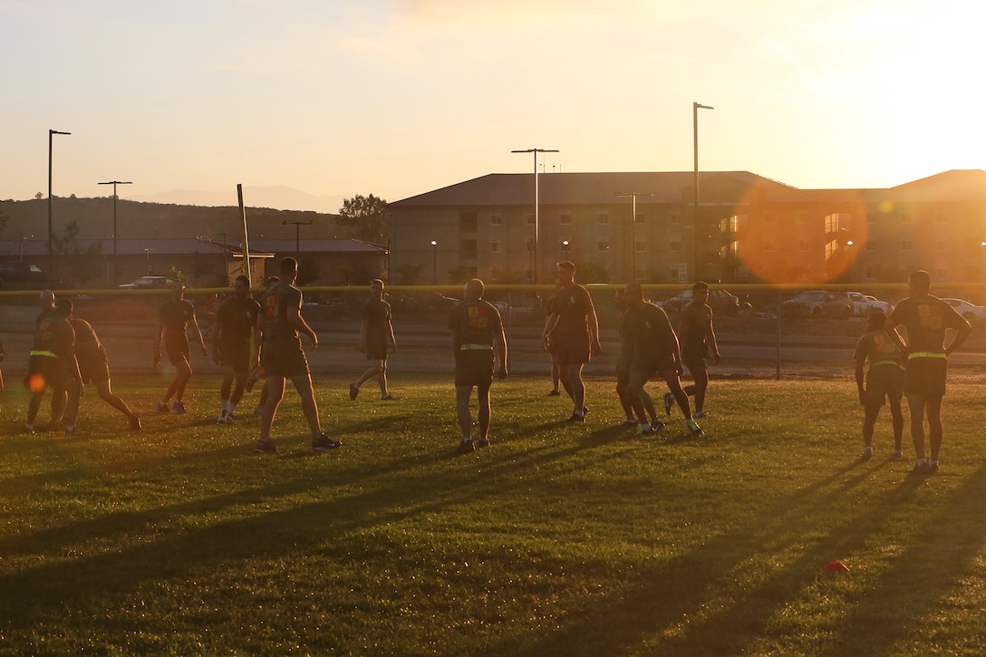 Marines with 1st Marine Logistics Group, play football during morning physical training as part of the Corporal's Course aboard Camp Pendleton, Calif., Sept. 25, 2013. The course is a 15-day training event designed to teach Marines the knowledge and skills necessary to become successful non-commissioned officers. Fifty-two Marines with 1st MLG participated in the cycle conducted from Sept. 9 - 27, 2013. 