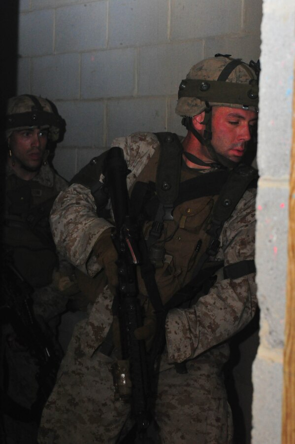 Marines round the corner of a hallway during a training exercise aboard Marine Corps Base Quantico on Sept. 25, 2013. Charlie Co. Marines participated in urban combat training as one of the last field exercises they will conduct before their graduation from the Basic School on Oct. 30, 2013.(U.S. Marine Corps photo by Lance Cpl. Samuel Ellis/ Released)