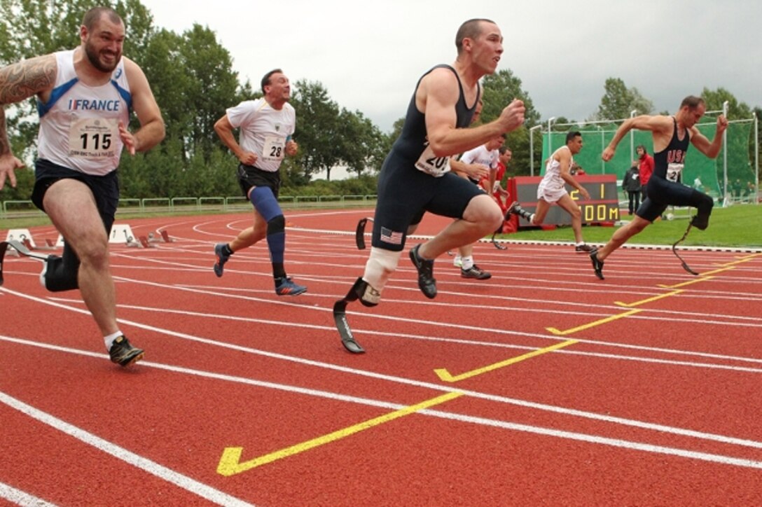 SGT Robert Brown (far right) and SGT Ryan McIntosh (center) sprint in the 100m Class A (Below Knee Amputee) of the 2013 CISM Open Integrated/Para Track and Field Championship in Warendorf, Germany 9-16 September.  Brown and McIntosh both with the Army's World Class Athlete Program, won gold and silver respectively.  